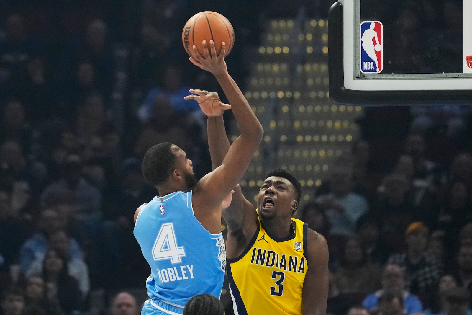 Cleveland Cavaliers forward Evan Mobley (4) shoots over Indiana Pacers center Thomas Bryant (3) in the first half of an NBA basketball game, Sunday, Jan. 12, 2025, in Cleveland. (AP Photo/Sue Ogrocki)