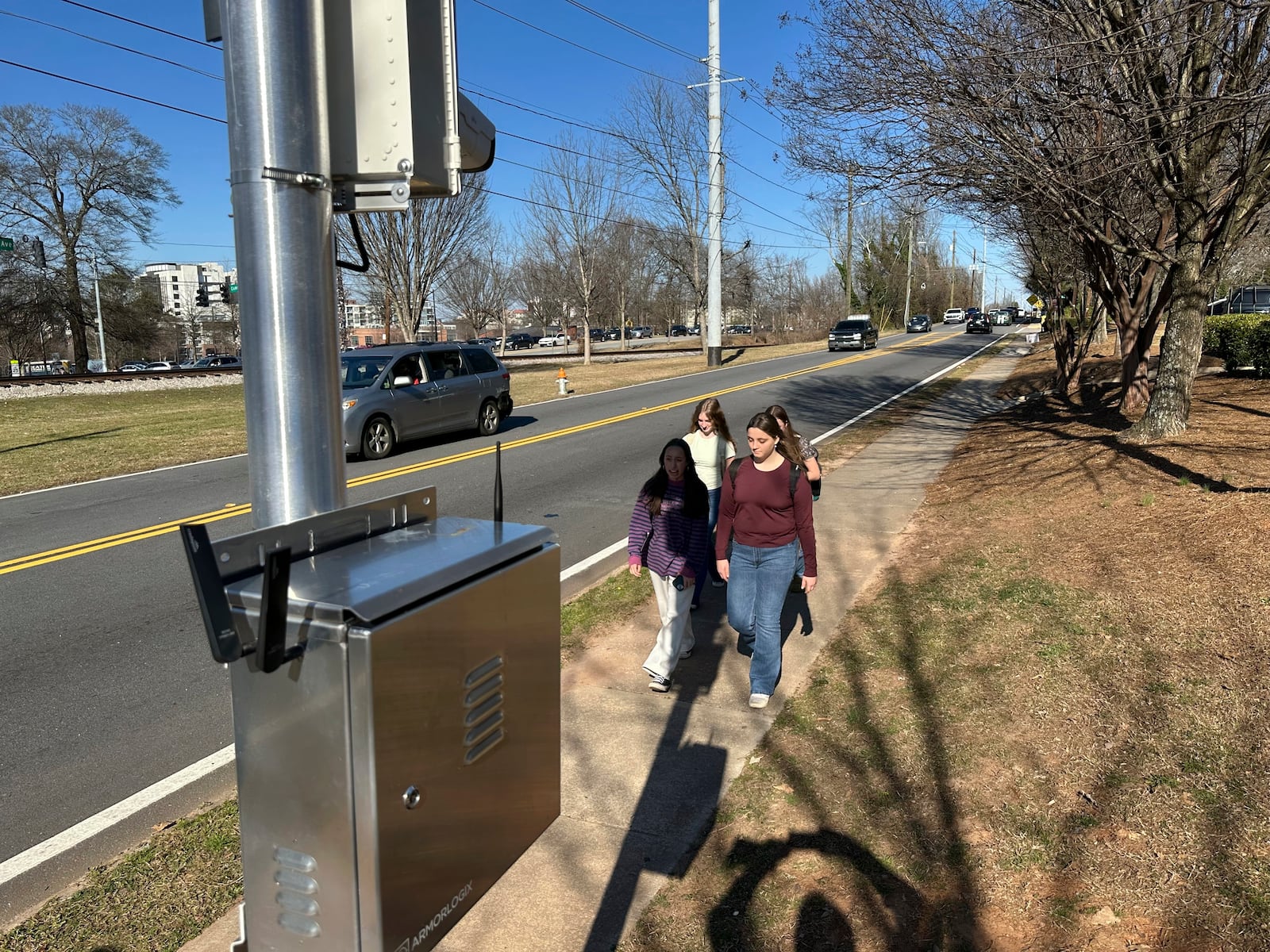 Students walk home past an automated speed camera outside Beacon Hill Middle School in Decatur, Ga., on Tuesday, Feb. 25, 2025. (AP Photo/Jeff Amy)