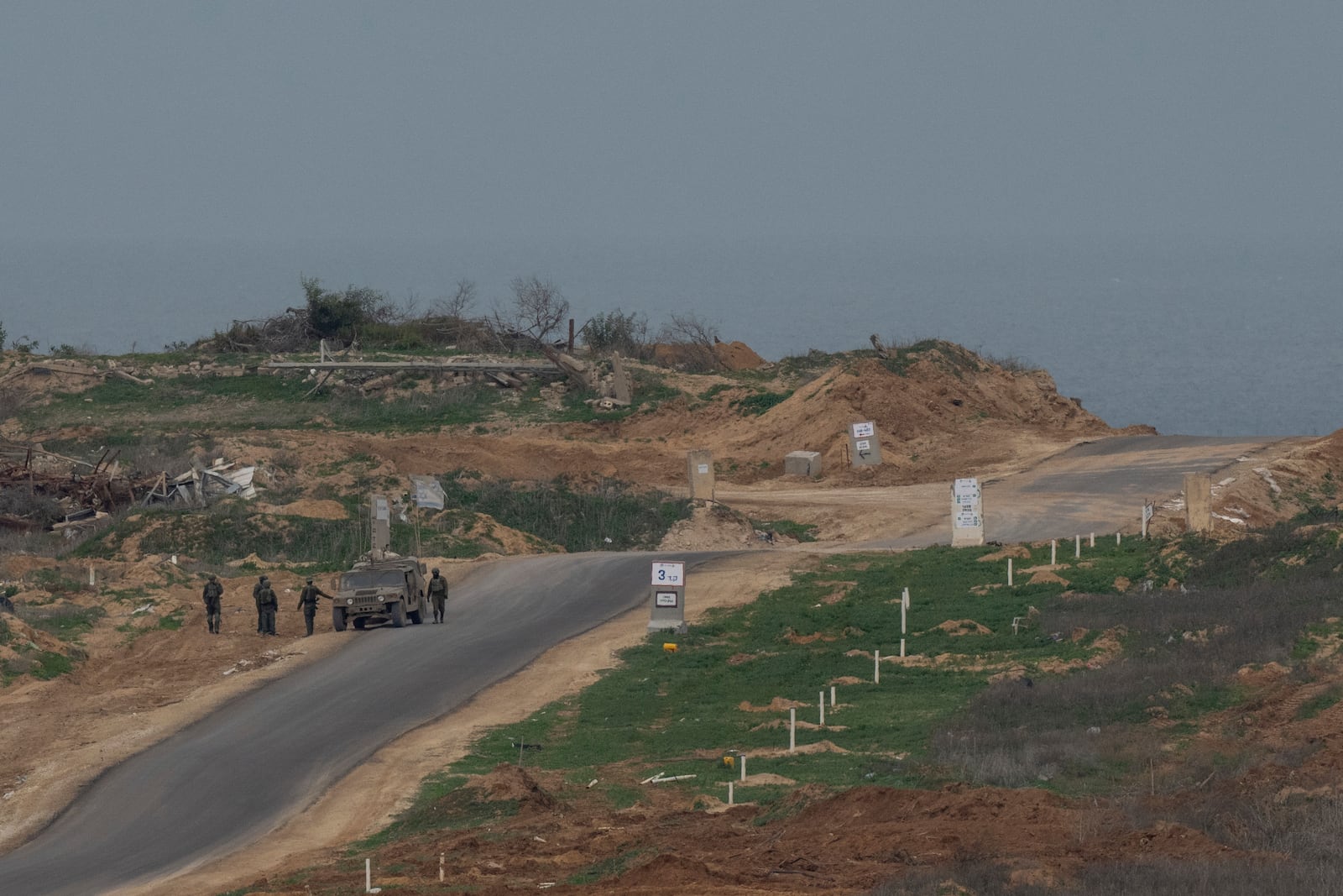 Israeli soldiers inside the northern Gaza Strip as seen from southern Israel, Sunday, Feb. 9, 2025. (AP Photo/Ohad Zwigenberg)