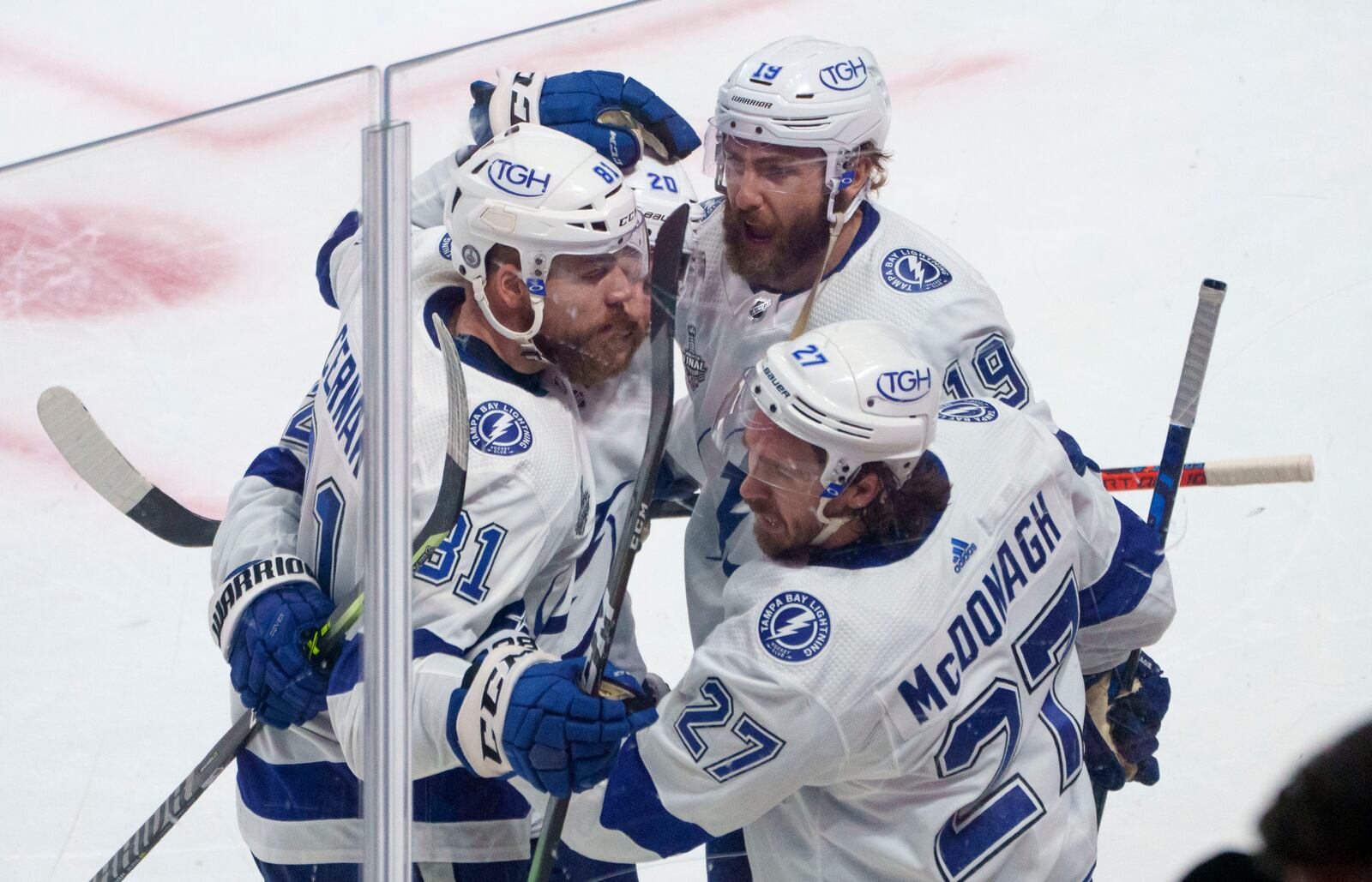 Tampa Bay Lightning's Barclay Goodrow (19) celebrates his goal against the Montreal Canadiens with teammates Erik Cernak (81), Blake Coleman and Ryan McDonagh (27) during the second period of Game 4 of the NHL hockey Stanley Cup final against the Tampa Bay Lightning in Montreal, Monday, July 5, 2021. (Paul Chiasson/The Canadian Press via AP)