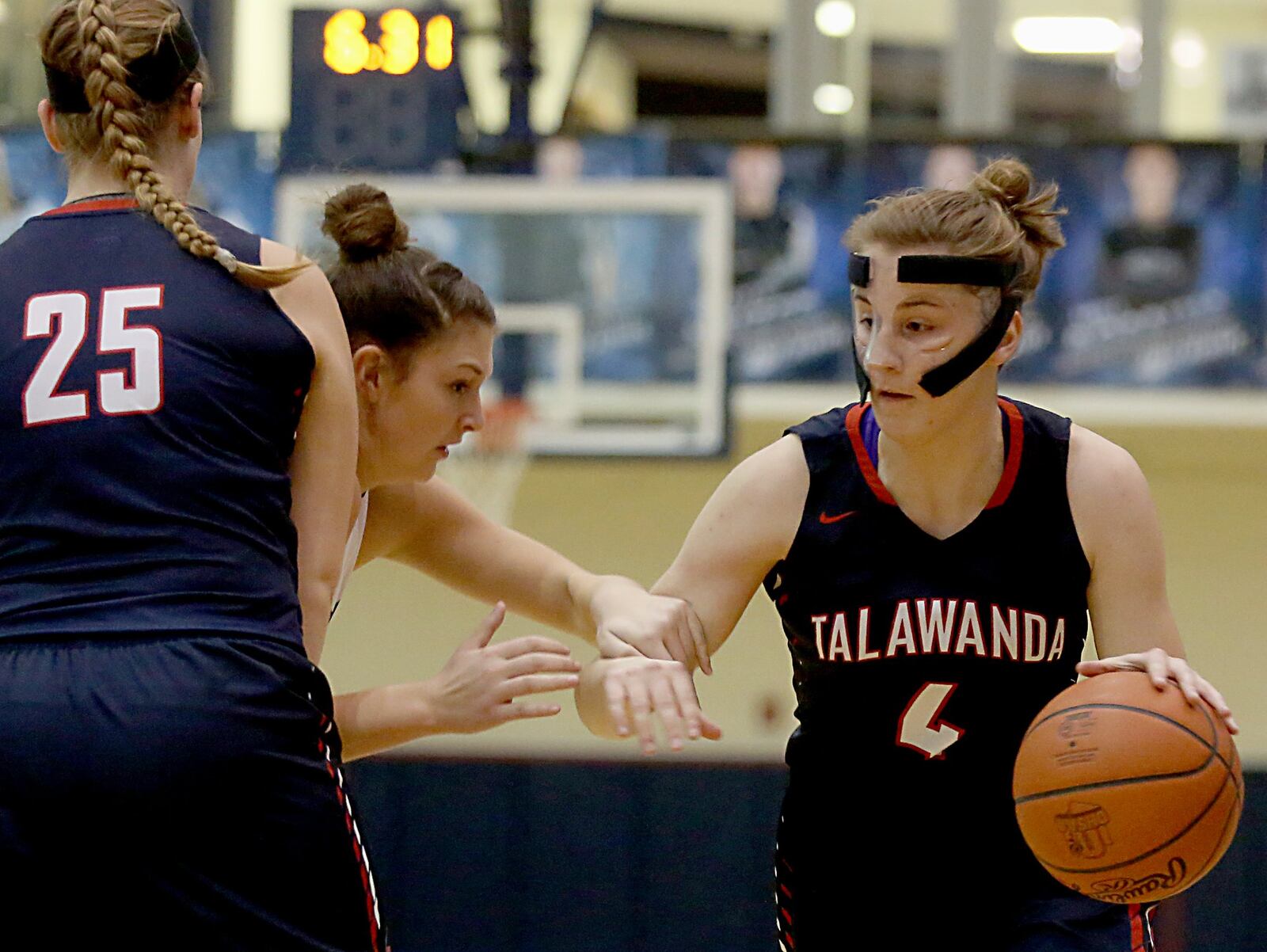 Talawanda guard Emma Wright (4) takes advantage of the pick set on Edgewood forward Sara Schaefer by Katlynn Woodruff (25) during their game at Ron Kash Court in Trenton on Wednesday night. CONTRIBUTED PHOTO BY E.L. HUBBARD