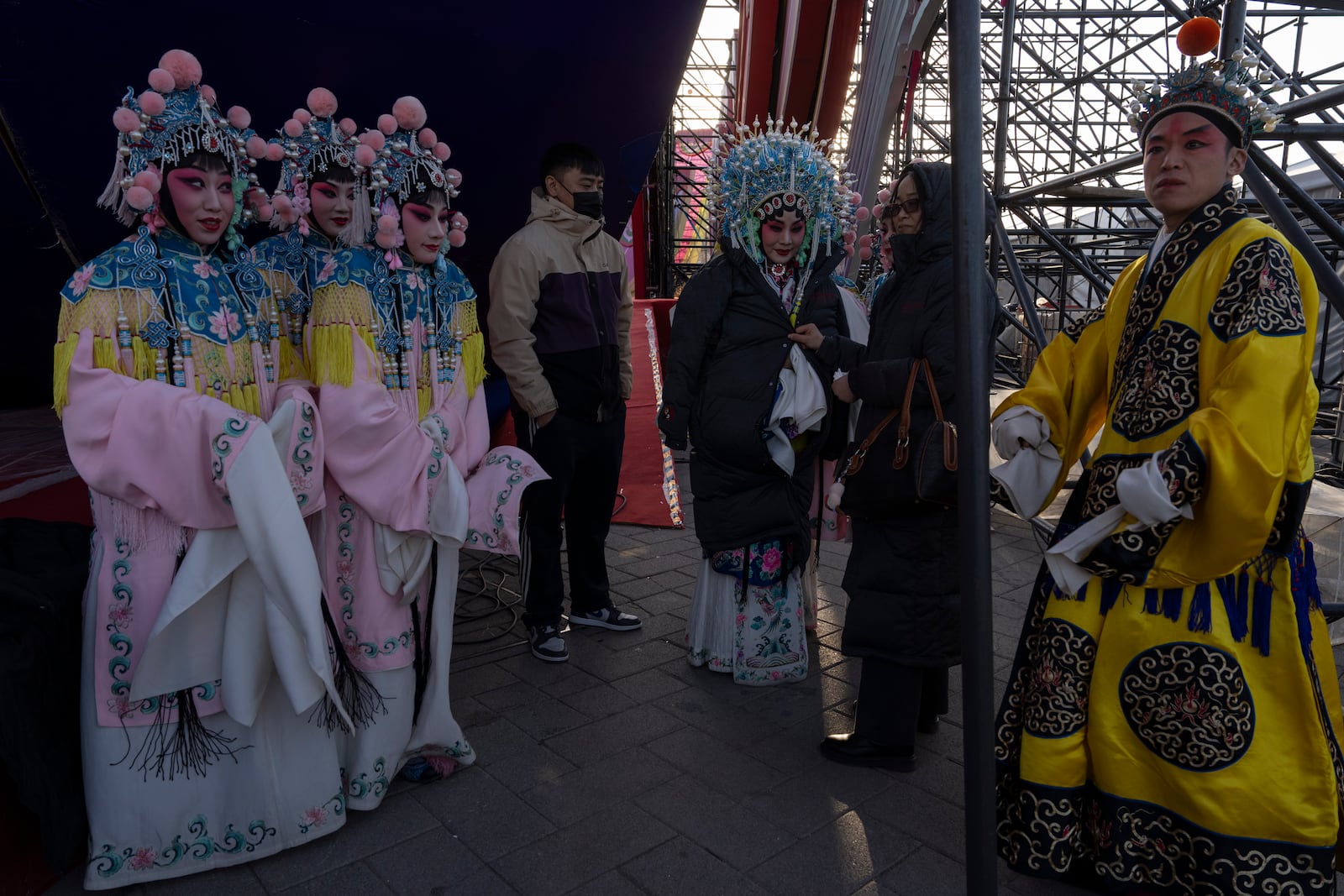 Chinese opera performers wait in the cold backstage before a show for Lantern Festival during Yuanxiao, the fifteen day of the Lunar New Year in Beijing, Wednesday, Feb. 12, 2025. (AP Photo/Ng Han Guan)