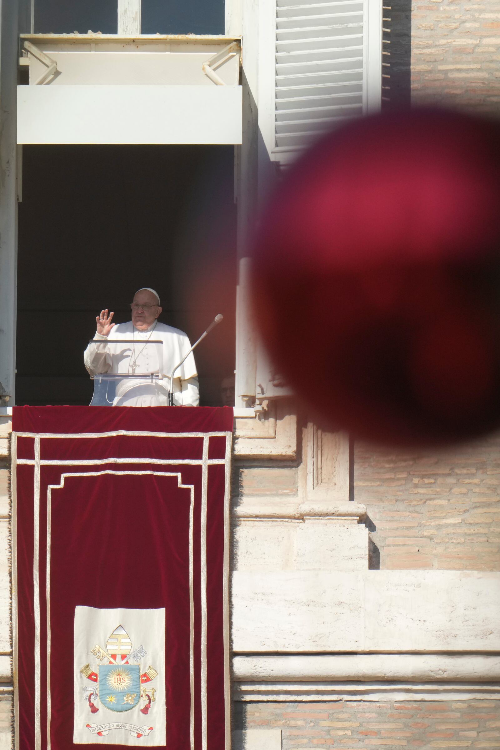 Pope Francis appears at his studio's window overlooking St. Peter's Square at The Vatican to bless pilgrims and faithful after presiding over a mass in St. Peter's Basilica on New Year's Day, Wednesday, Jan. 1, 2025. (AP Photo/Andrew Medichini)