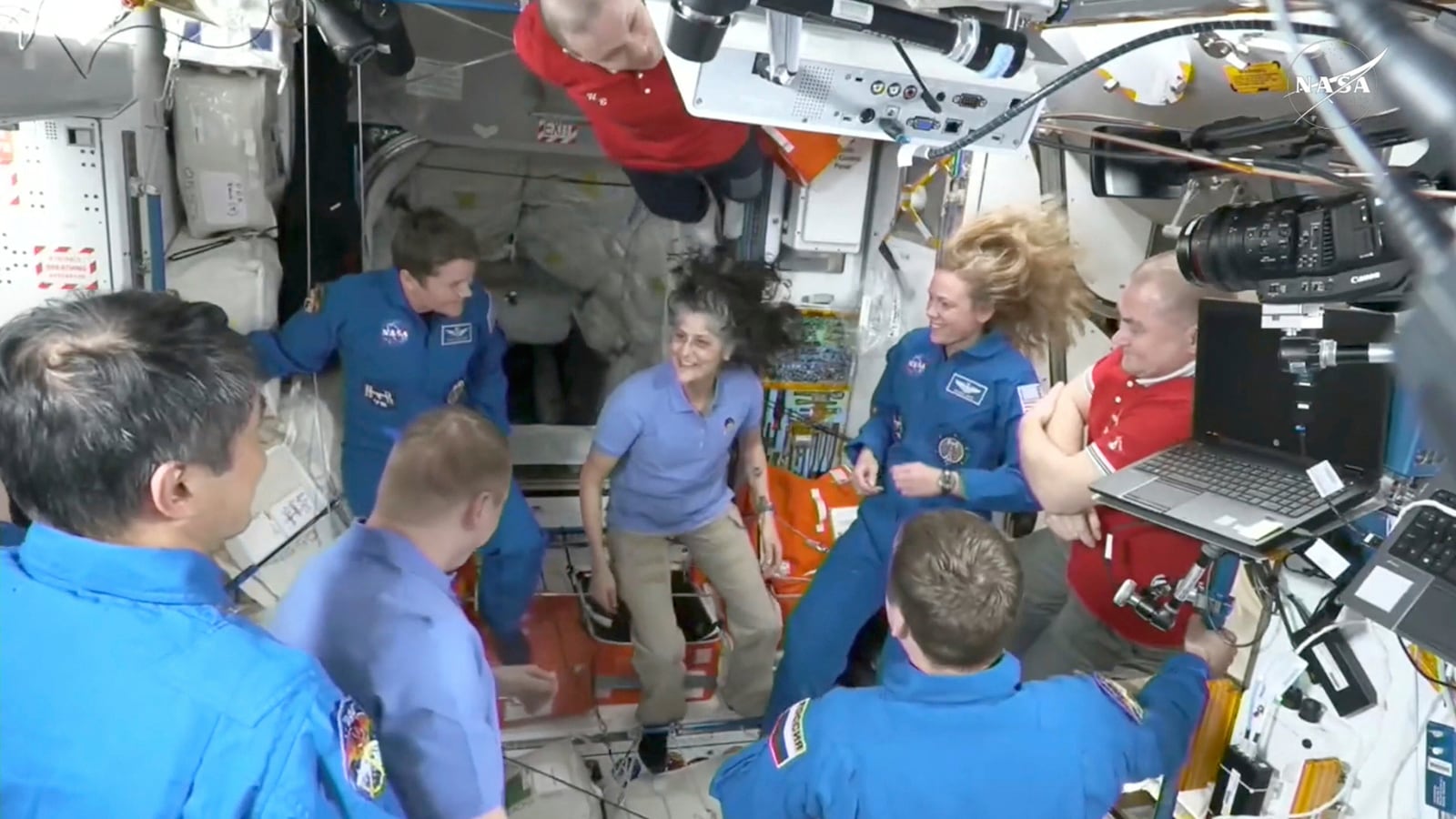 This image made from video by NASA shows astronauts, including Suni Williams, center, greeting each other after a SpaceX capsule docked with the International Space Station, Sunday, March 16, 2025. (NASA via AP)