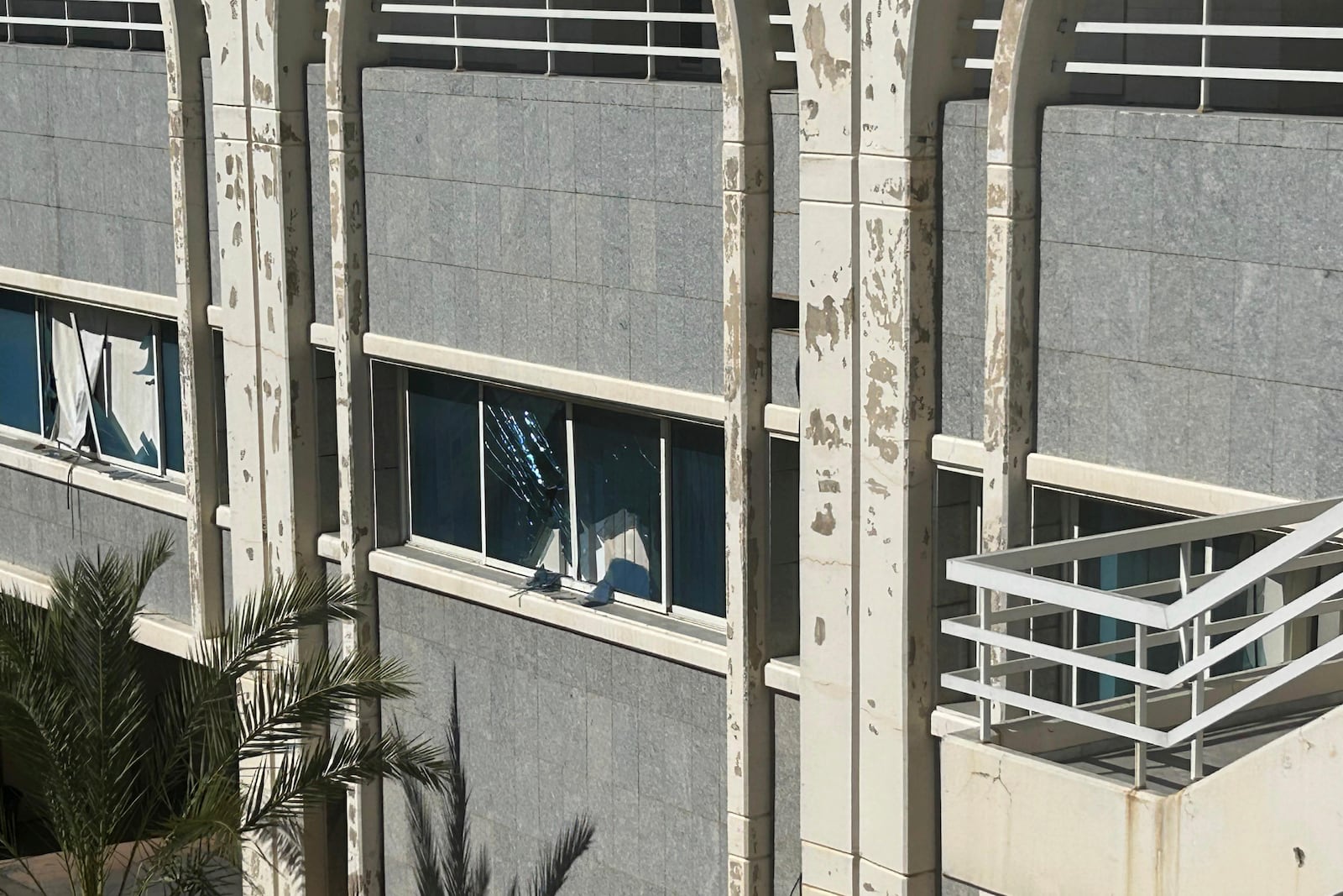 Broken window in the building of the Rafik Hariri University Hospital, following an overnight Israeli airstrike near the medical facility in southern Beirut, Lebanon, Tuesday, Oct. 22, 2024. (AP Photo/Sarah el-Deeb)