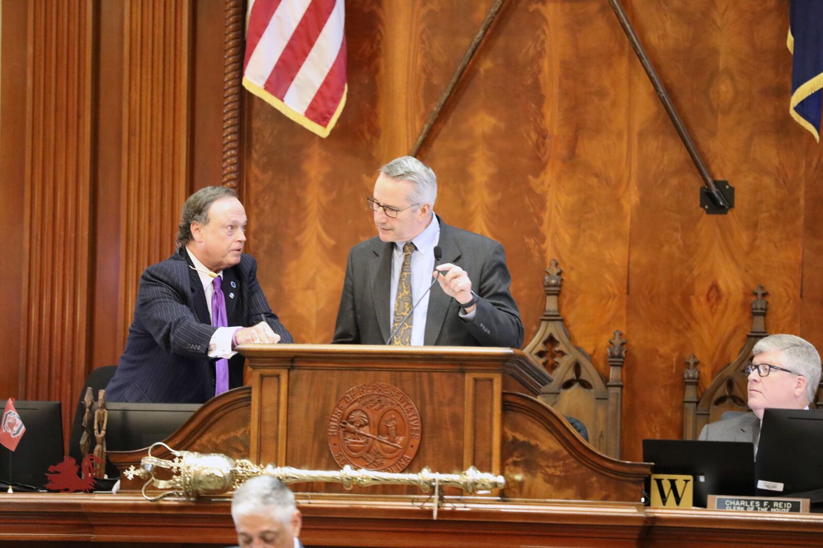 South Carolina House Reading Clerk Bubba Cromer, left, talks to Speaker Pro Tem Tommy Pope, R-York, right during the House budget debate on Tuesday, March 11, 2025, in Columbia, S.C. (AP Photo/Jeffrey Collins)