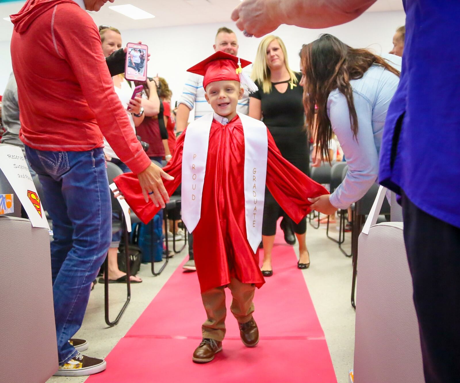 Fairfield Central Elementary School first grader Walter Herbert is battling a rare form of cancer. The school district accelerated his journey to graduation with short visits to classrooms in all the grade levels. Central Elementary held a graduation ceremony for him Friday, Sept. 8, complete with cap and gown. Walter walked down the aisle with his family, including his parents, Wally and Emily. GREG LYNCH / STAFF