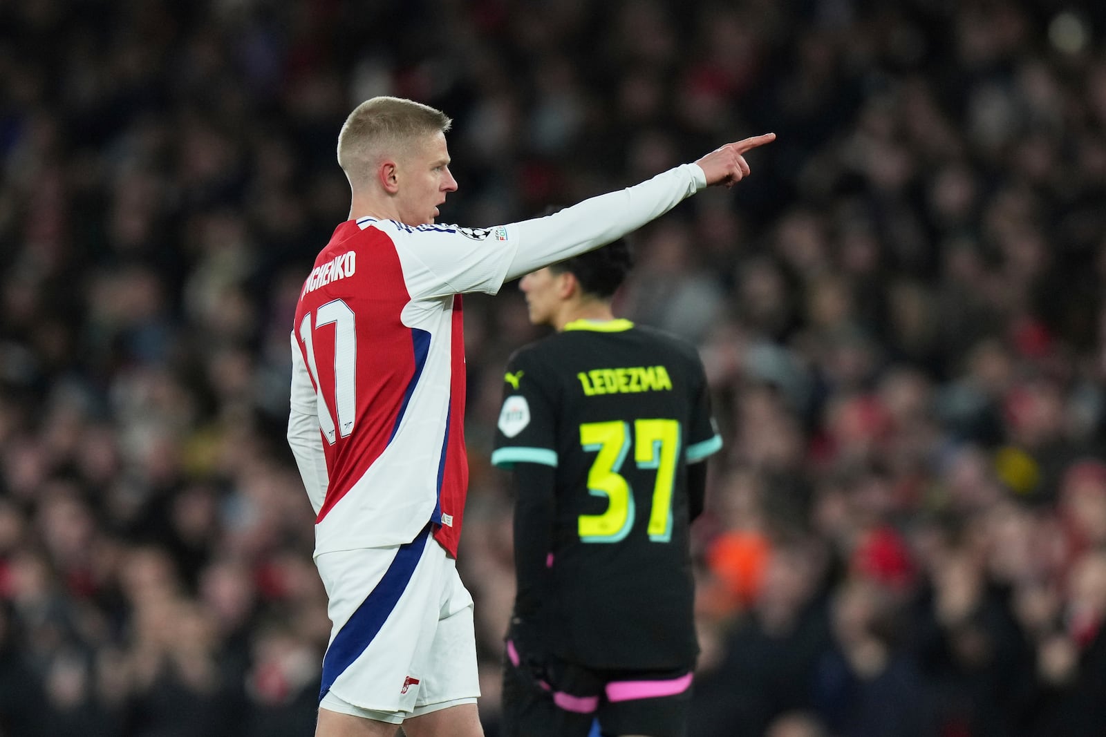 Arsenal's Oleksandr Zinchenko celebrates after scoring his side's opening goal during the Champions League round of 16 second leg soccer match between Arsenal FC and PSV Eindhoven at the Arsenal stadium in London, England, Wednesday, March 12, 2025. (AP Photo/Alastair Grant)