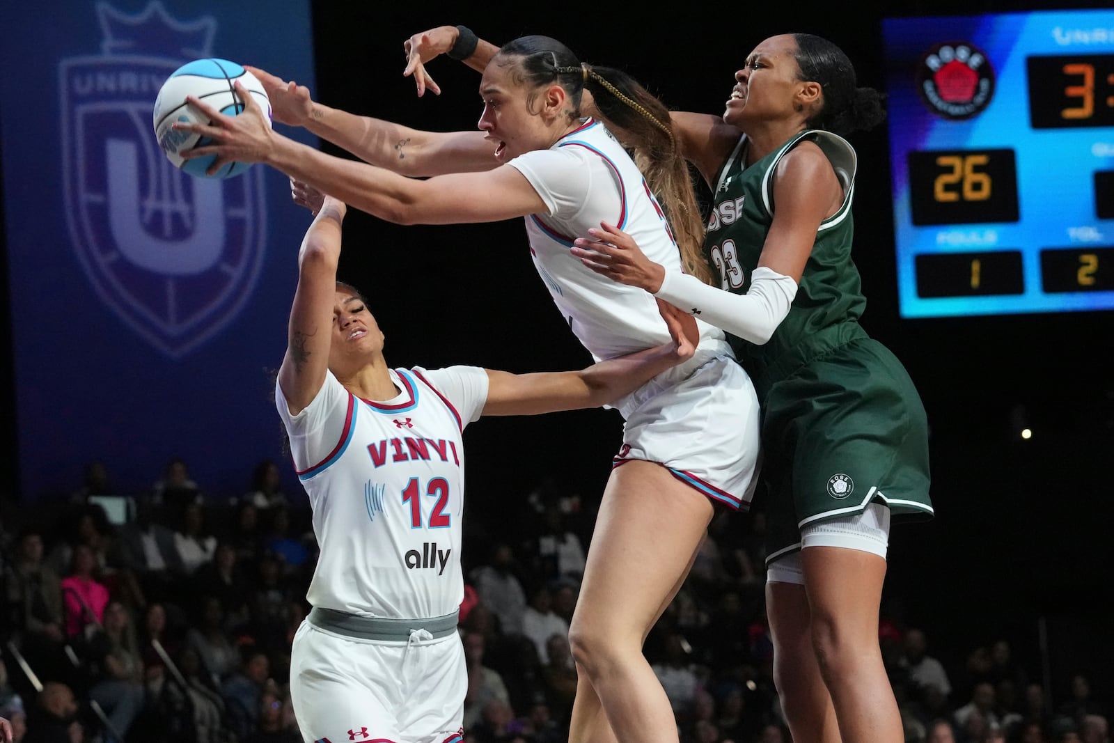 Vinyl's Dearica Hamby (5) catches a rebound as Rose's Azura Stevens (23) defends during the first half of the 3-on-3 basketball game, Friday, Jan. 17, 2025, in Medley, Fla. (AP Photo/Marta Lavandier)