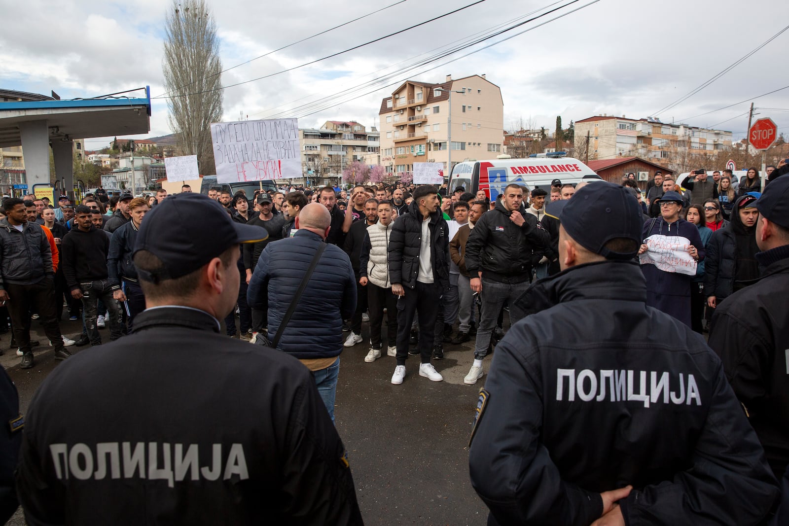 People confront police near the home of the owner of a nightclub that was the scene of a massive fire, after a vigil for the victims in the town of Kocani, North Macedonia, Monday, March 17, 2025. (AP Photo/Visar Kryeziu)