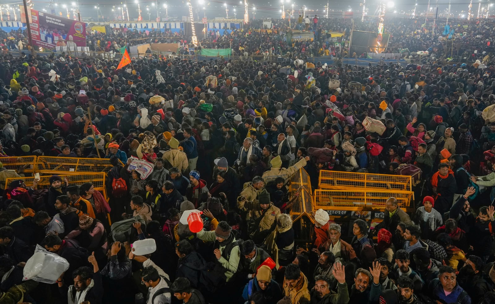 Hindu devotees gather for a holy dip by the banks of the Sangam, the confluence of the Ganges, the Yamuna and the mythical Saraswati rivers, on Mauni Amavasya' or new moon day during the Maha Kumbh festival in Prayagraj, Uttar Pradesh, India, Wednesay, Jan. 29, 2025. (AP Photo/Deepak Sharma)