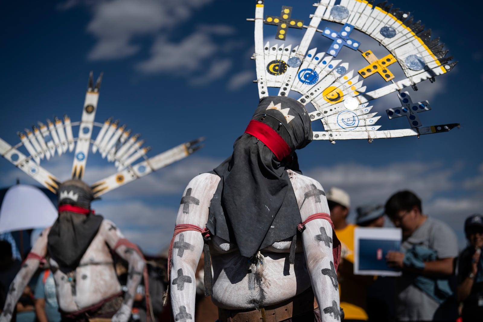 Ceremonial dancers wait to perform at a "Get out the vote" or GOTV event in a push for Native Americans to vote in the upcoming presidential election, on Navajo Nation in Fort Defiance, Ariz., Saturday, Oct. 12, 2024. In the lead up to U.S. elections in November, Democrats and Republicans have flocked the furthest reaches of 22 Native American reservations in Arizona in a bid to court their votes. (AP Photo/Rodrigo Abd)