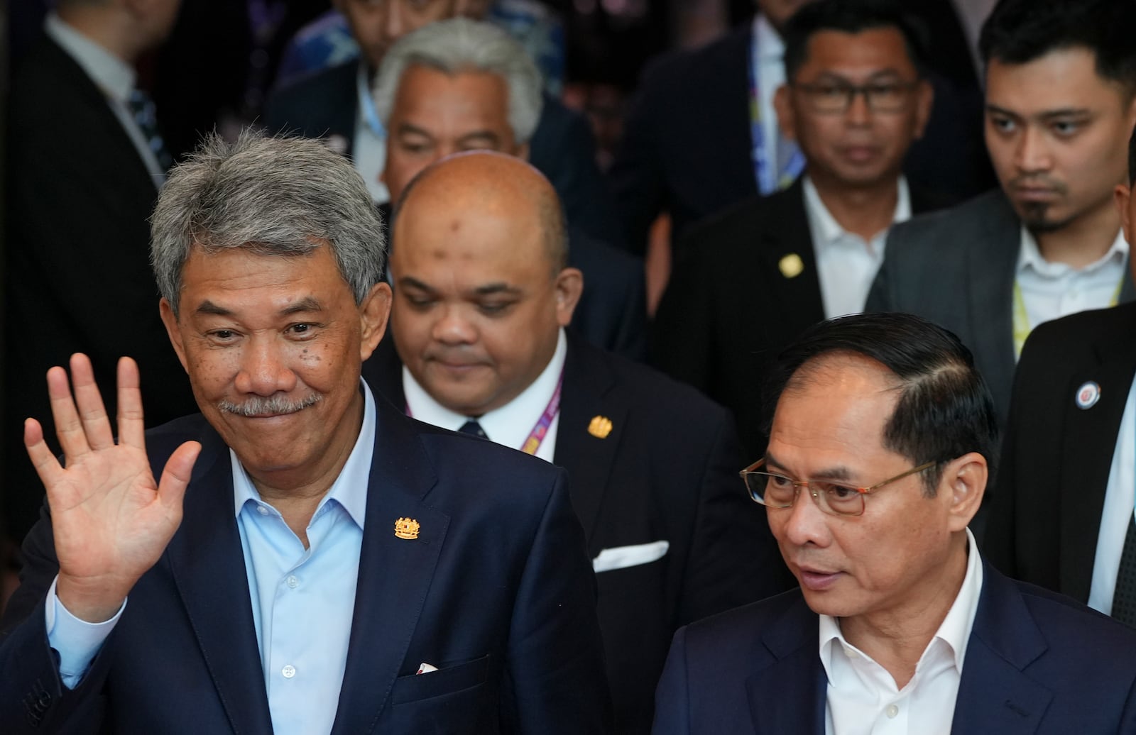 Malaysia's Foreign Minister Mohamad Hasan, left, waves to members of the media after the Association of Southeast Asian Nations (ASEAN) Foreign Ministers' Retreat in Langkawi Island, Malaysia, Sunday, Jan. 19, 2025. (AP Photo/Azneal Ishak, Pool)