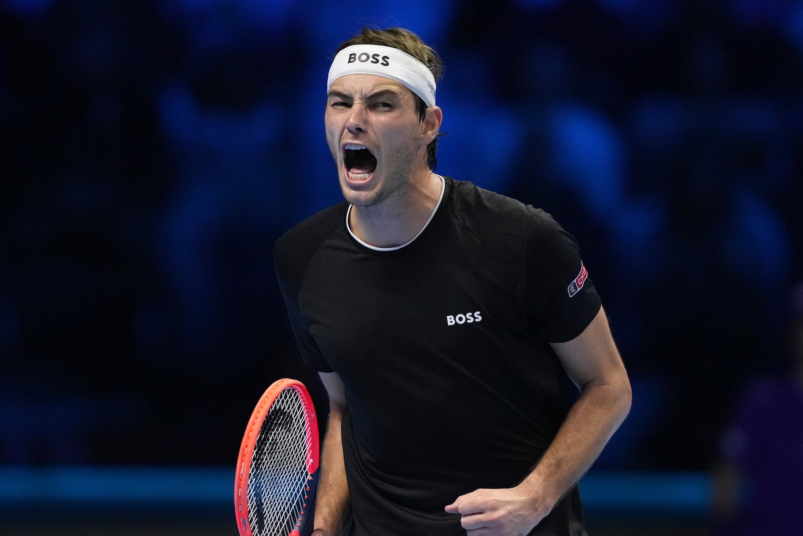 United States' Taylor Fritz reacts after winning a point against Australia's Alex de Minaur during their singles tennis match of the ATP World Tour Finals at the Inalpi Arena, in Turin, Italy, Thursday, Nov. 14, 2024. (AP Photo/Antonio Calanni)