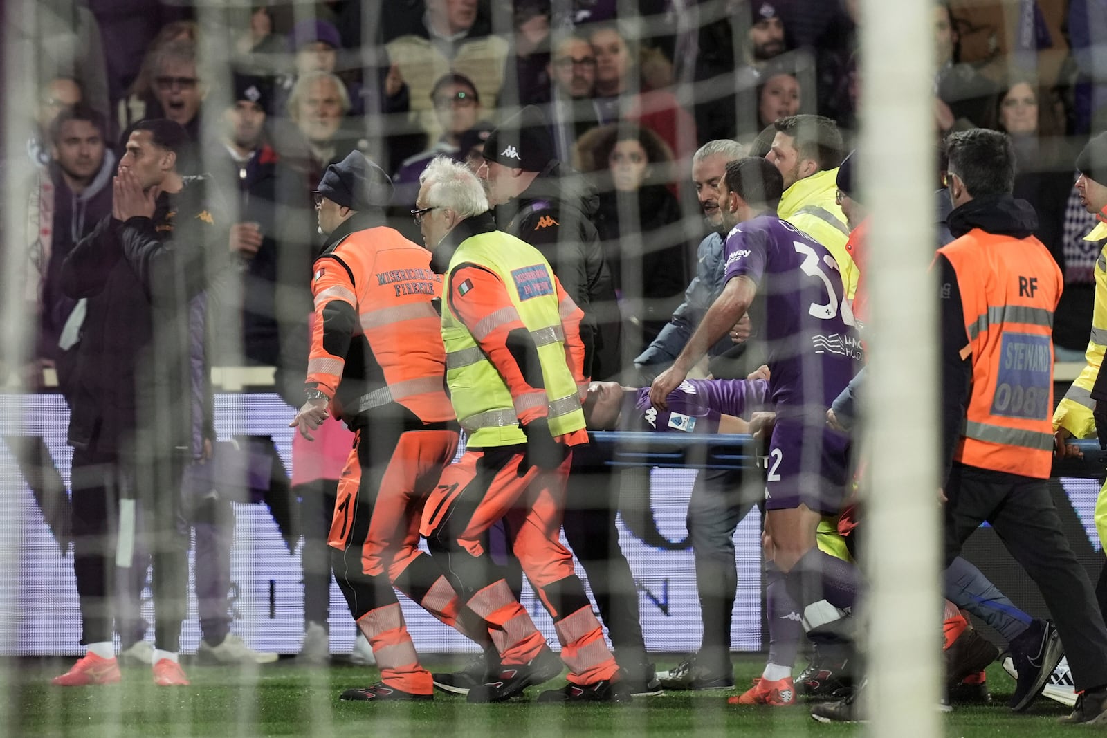 Fiorentina's Edoardo Bove, injured, is transported to a waiting ambulance during the Serie A soccer match between Fiorentina and Inter at the Artemio Franchi Stadium in Florence, Italy, Sunday Dec. 1, 2024. The match was suspended and finally postponed as the injures appeared to be serious. (Massimo Paolone/LaPresse via AP)