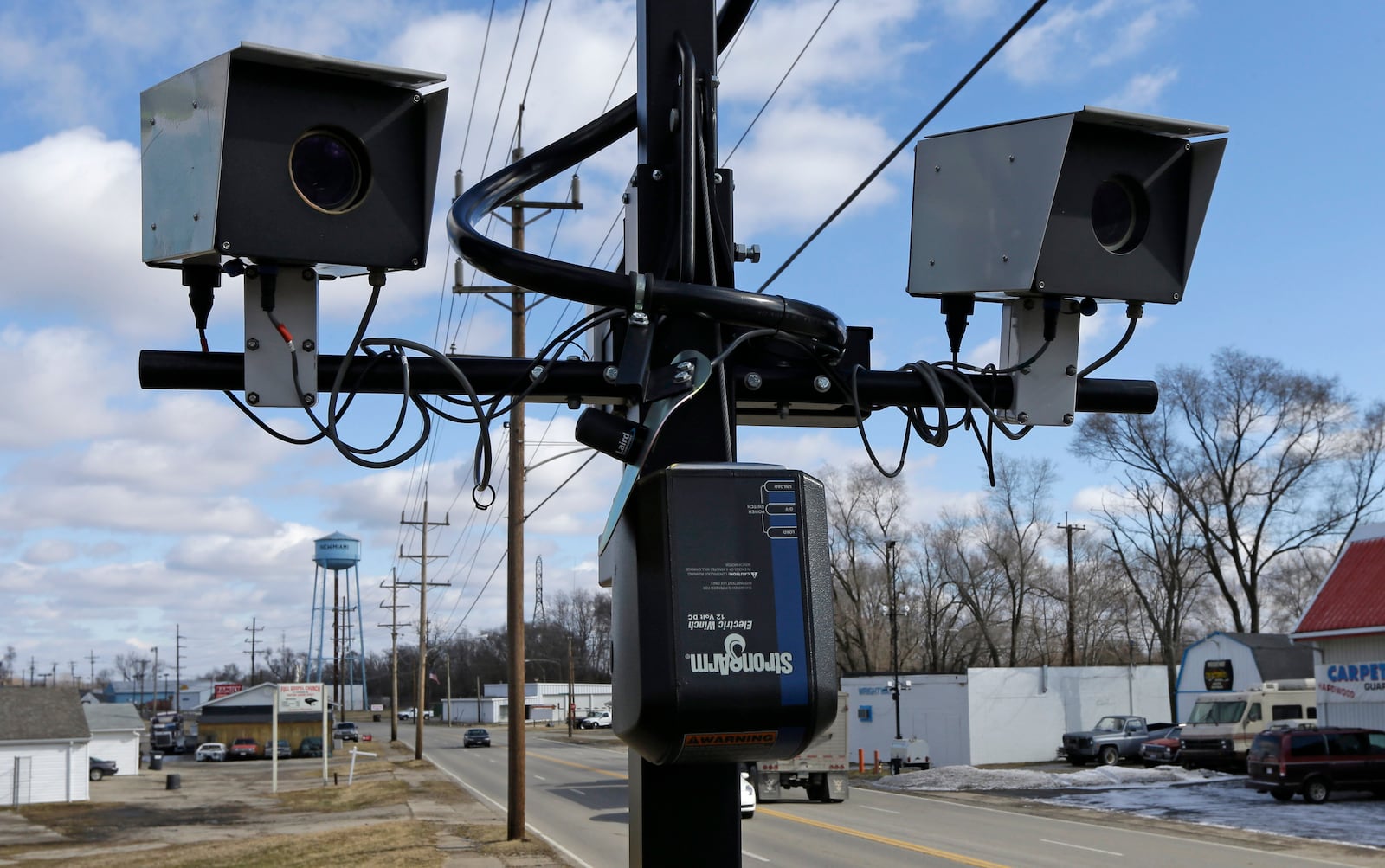 FILE - Speed cameras are aimed at U.S. Route 127, in New Miami, Ohio, Feb. 25, 2014 . Under new federal guidance issued Wednesday, Feb. 2, 2022, states can now tap billions of federal highway dollars for roadway safety programs such as automated traffic enforcement. They are being told that cameras that photograph speeding vehicles are an established way to help bring down rising traffic deaths. (AP Photo/Al Behrman, File)