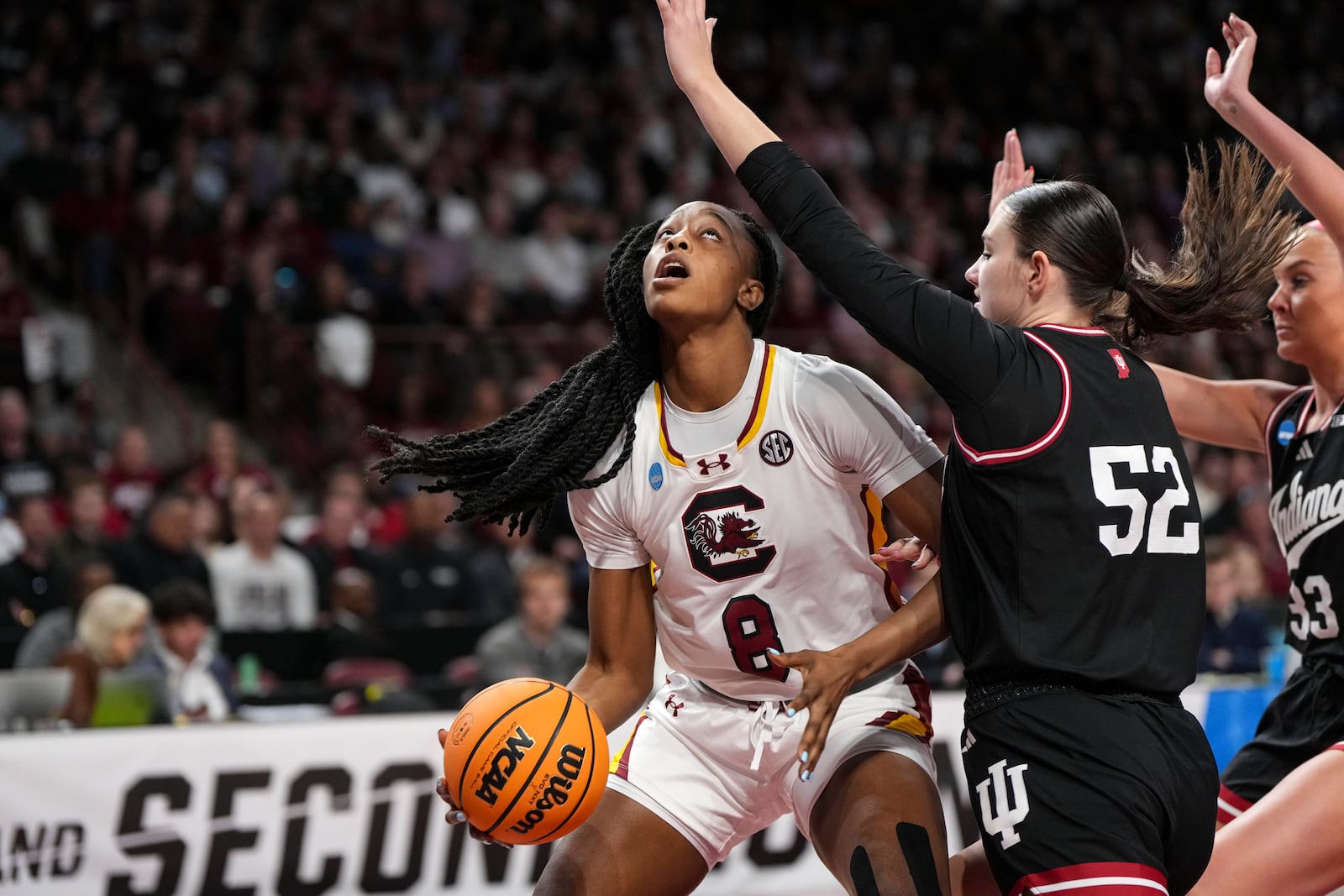 Indiana forward Lilly Meister (52) defends while South Carolina forward Joyce Edwards (8) looks for the basket during the first half in the second round of the NCAA college basketball tournament, Sunday, March 23, 2025, in Columbia, S.C. (AP Photo/David Yeazell)