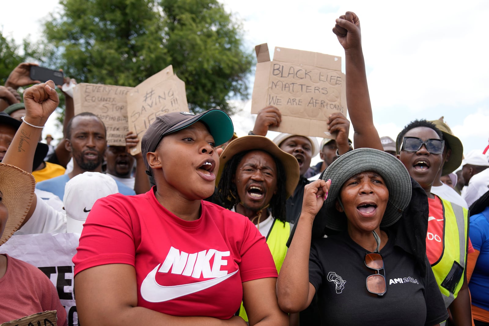 Families of miners and activist protest as South Africa's Police minister Senzo Mchunu visit an abandoned gold mine, where miners are rescued from below ground in an abandoned gold mine in Stilfontein, South Africa, Tuesday, Jan. 14, 2025. (AP Photo/Themba Hadebe)