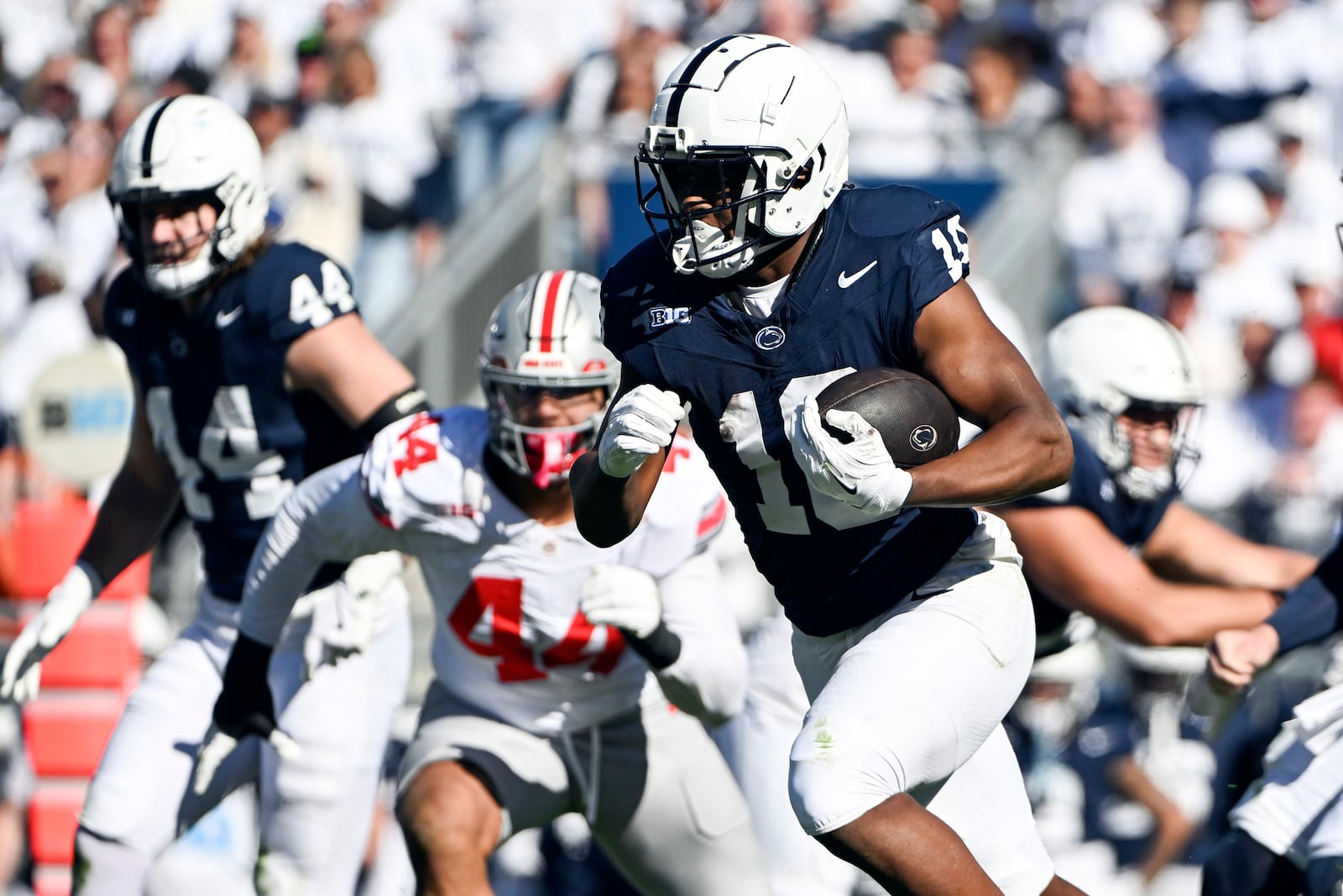 Penn State running back Nicholas Singleton (10) runs past Ohio State defensive end JT Tuimoloau (44) during the first quarter of an NCAA college football game, Saturday, Nov. 2, 2024, in State College, Pa. (AP Photo/Barry Reeger)