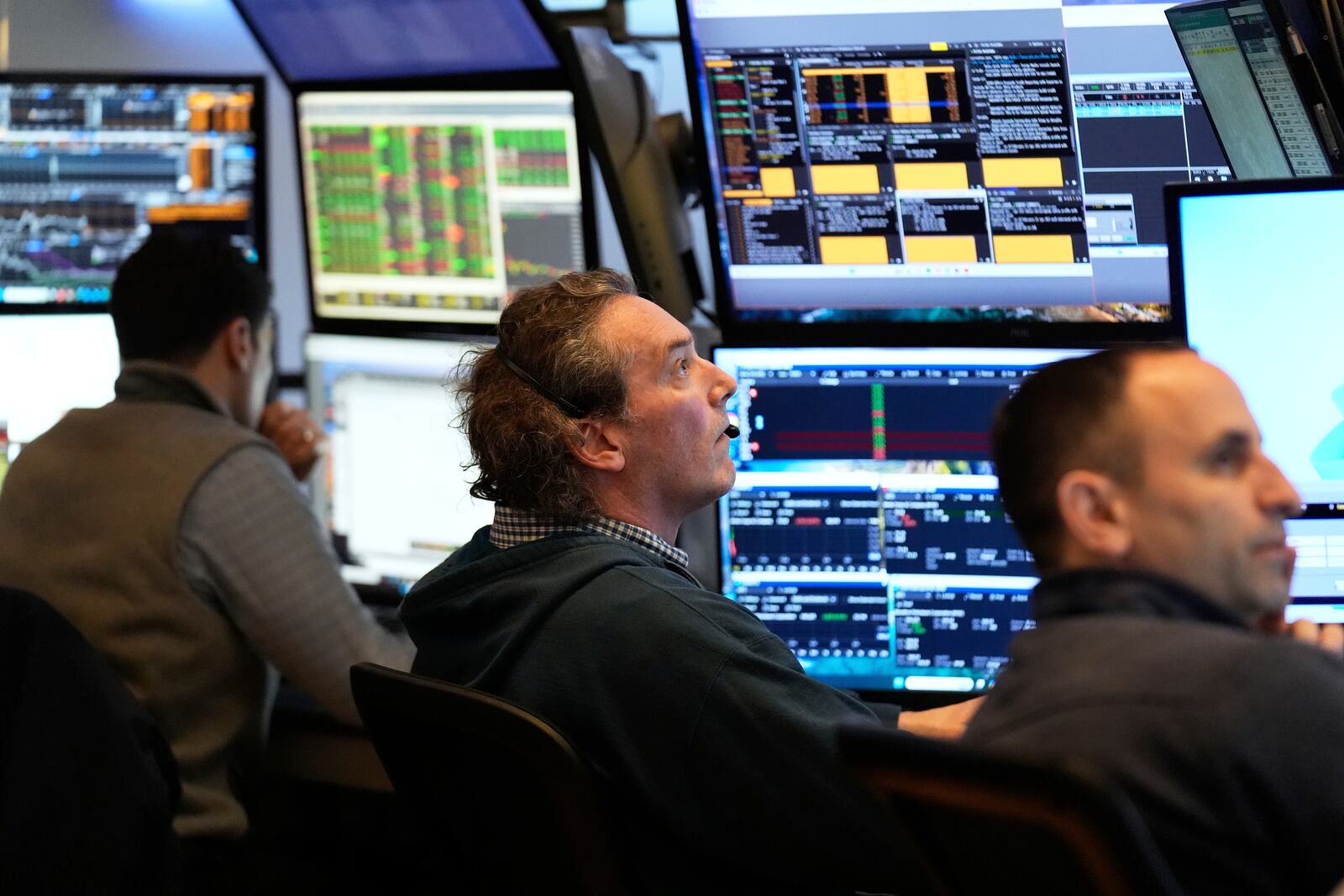 People work on the floor at the New York Stock Exchange in New York, Wednesday, March 19, 2025. (AP Photo/Seth Wenig)