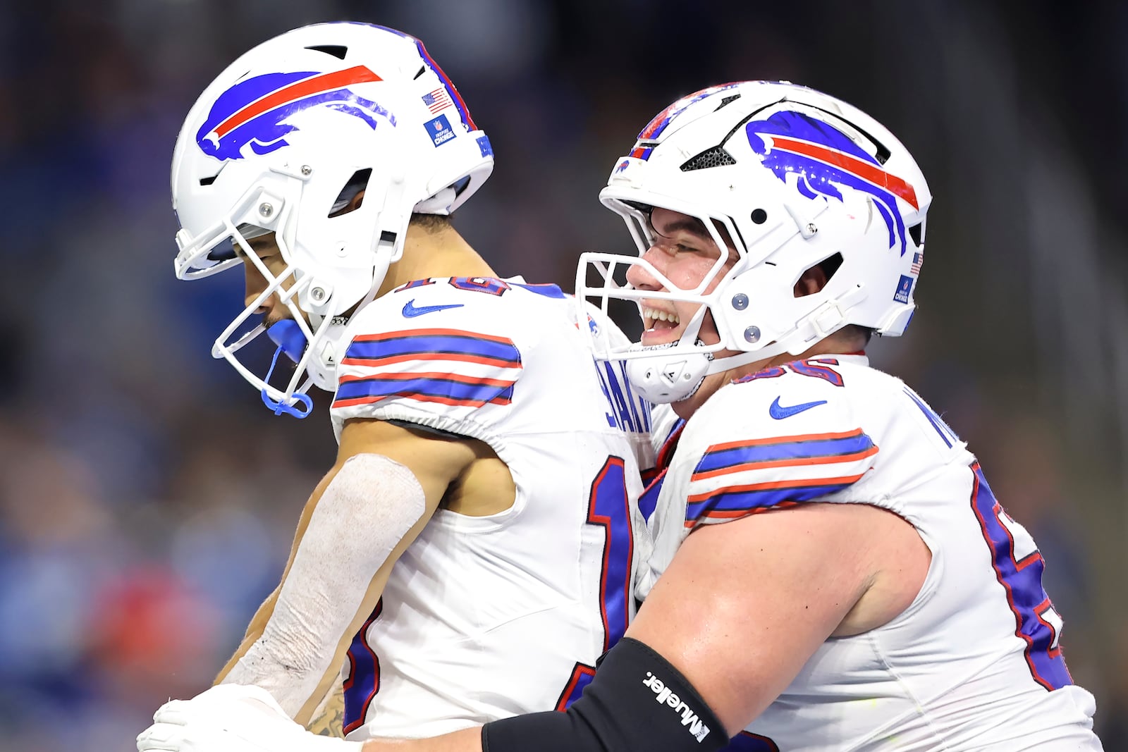 Buffalo Bills wide receiver Khalil Shakir, left, is congratulated by guard Connor McGovern after scoring against the Detroit Lions during the second half of an NFL football game, Sunday, Dec. 15, 2024, in Detroit. (AP Photo/Rey Del Rio)