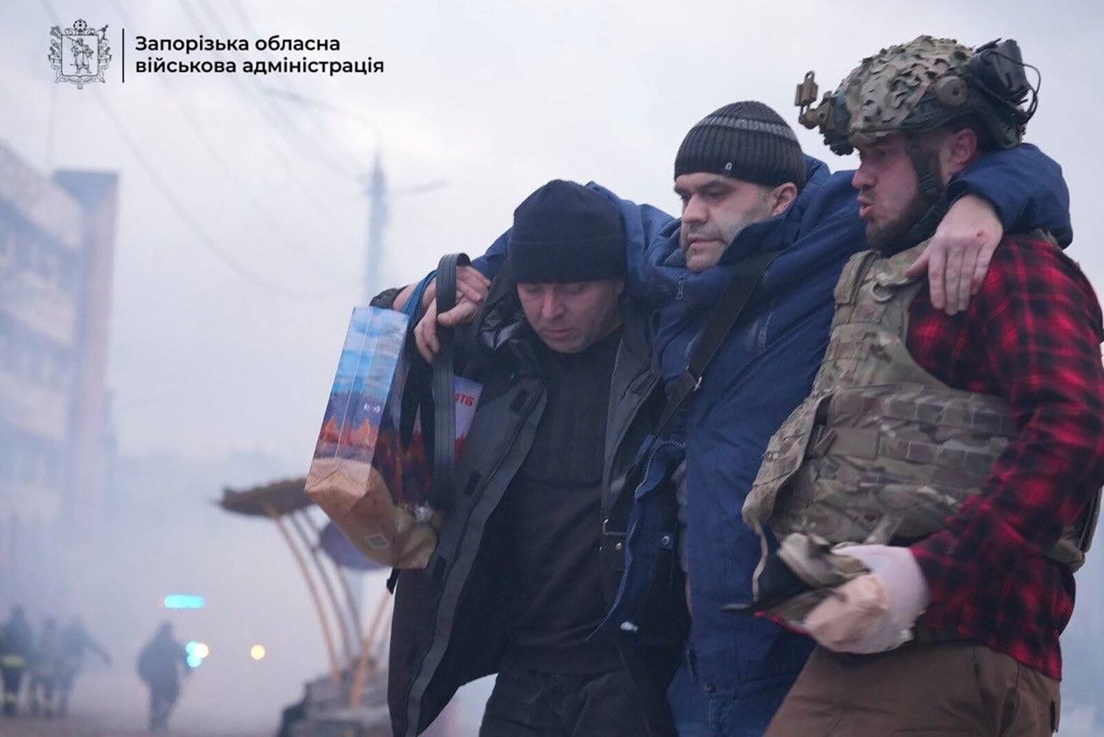 In this photo provided by the Zaporizhzhia regional military administration on Jan. 8, 2025, paramedics carry an injured man into an ambulance after a Russian air strike in Zaporizhzhia, Ukraine. (Zaporizhzhia regional military administration via AP)