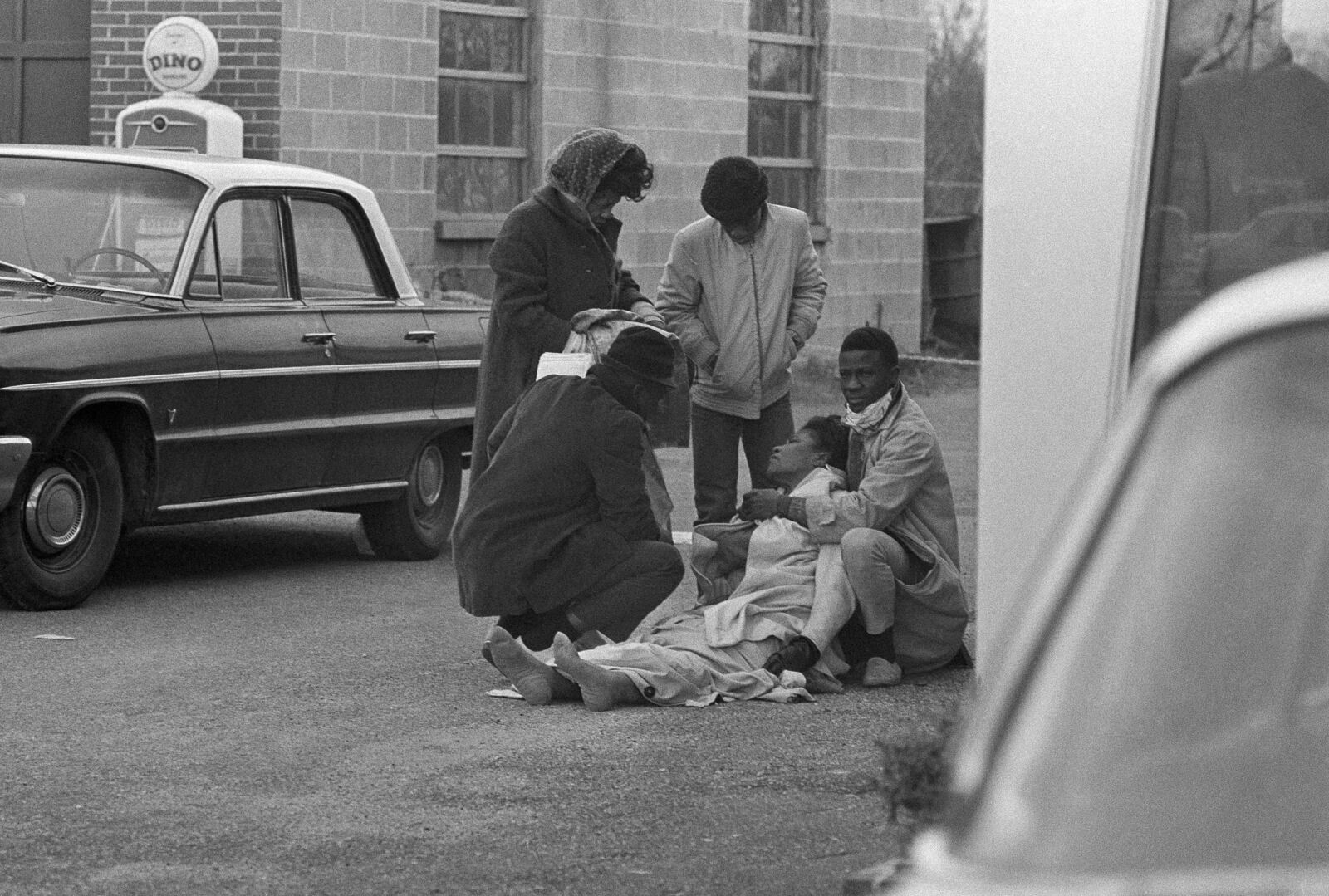 FILE - Amelia Boynton is aided by people after she was injured when state police broke up a demonstration march Boynton helped lead on the Edmund Pettus Bridge, in Selma, Ala., March 7, 1965. (AP Photo)