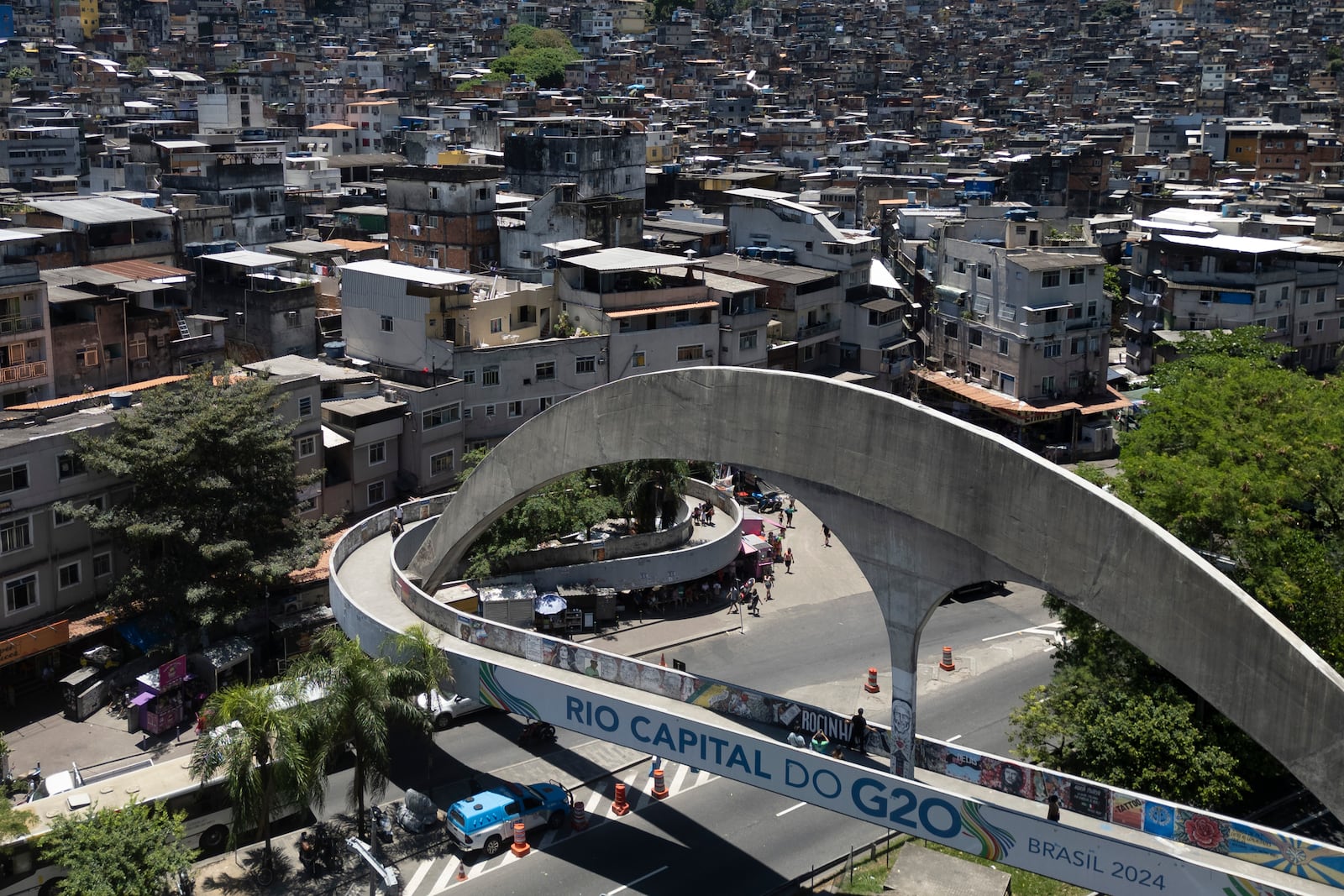 A pedestrian bridge leading to the Rocinha favela is covered by a sign that says in Portuguese: "Rio capital of the G20," in Rio de Janeiro, Wednesday, Nov. 6, 2024, ahead of the G20 Leaders' Summit. (AP Photo/Bruna Prado)