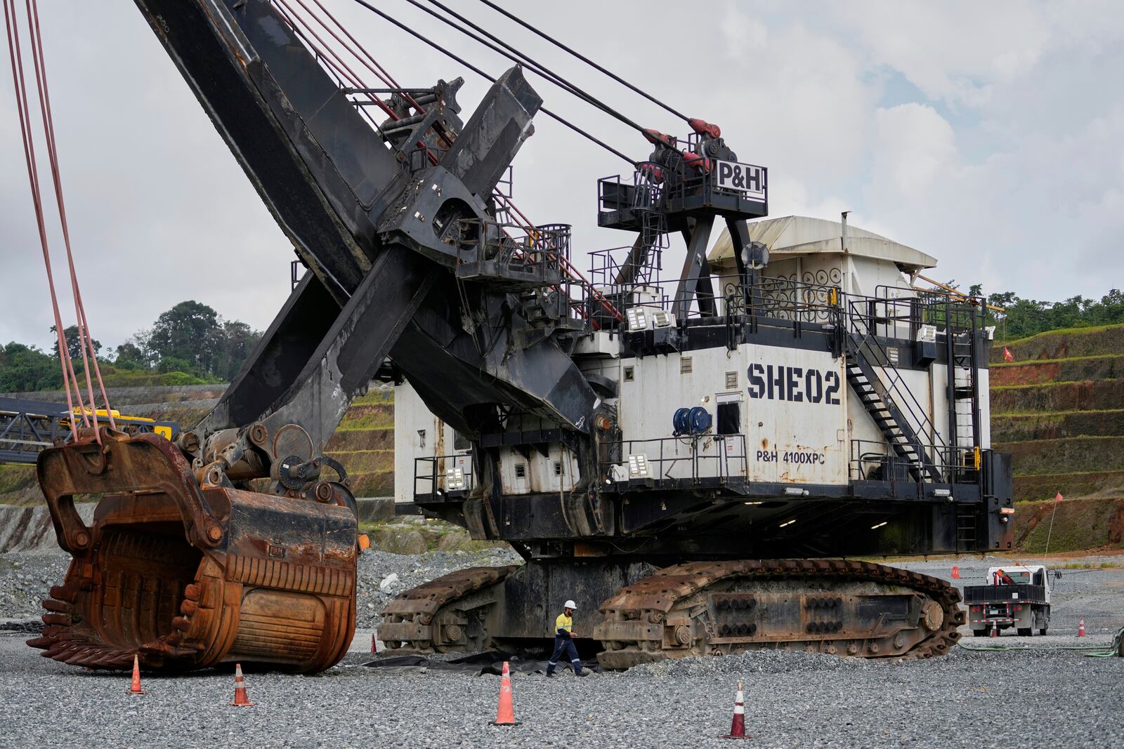 An excavator sits idle at the Cobre Panamá copper mine, owned by Canada's First Quantum Minerals, in Donoso, Panama, Friday, March 21, 2025, during a press tour of the mine that was closed after Panama's Supreme Court ruled that the government concession was unconstitutional. (AP Photo/Matias Delacroix)