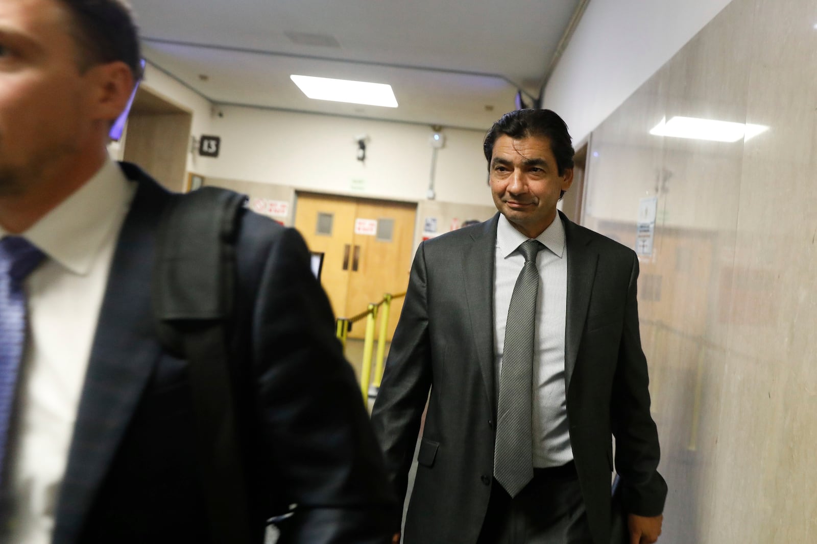 Attorney Tony Brass leaves Department 28 at the Hall of Justice on the first day of the trial of Nima Momeni, a tech consultant charged in the stabbing death of Cash App founder Bob Lee, Monday, Oct. 14, 2024, in San Francisco. (Lea Suzuki/San Francisco Chronicle via AP)