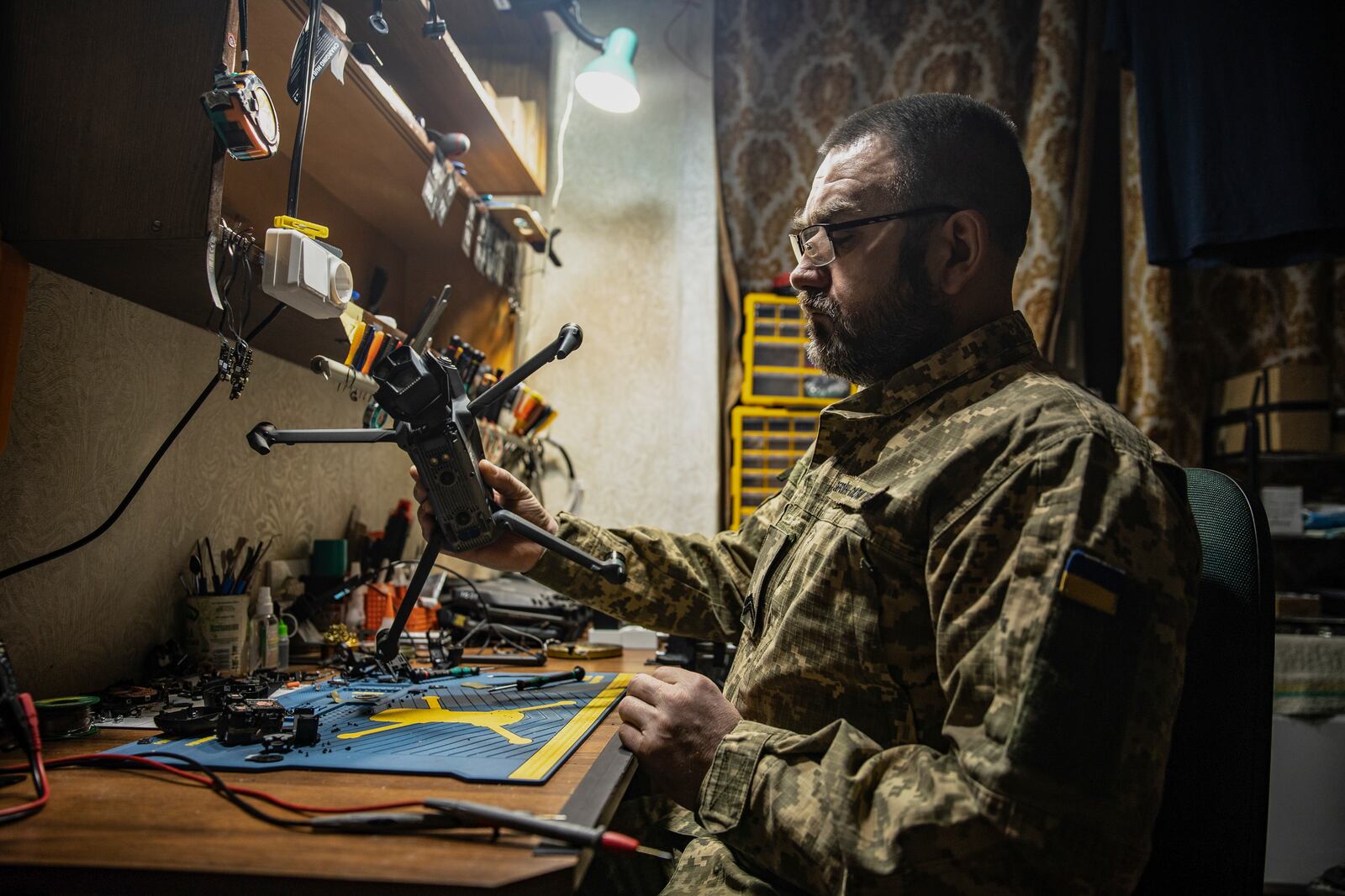 A Ukrainian soldier repairs a FPV drone in a drone repair workshop close to the front line near Siversk, Donetsk region, Ukraine, Thursday, Feb. 6, 2025. (AP Photo/Roman Chop)