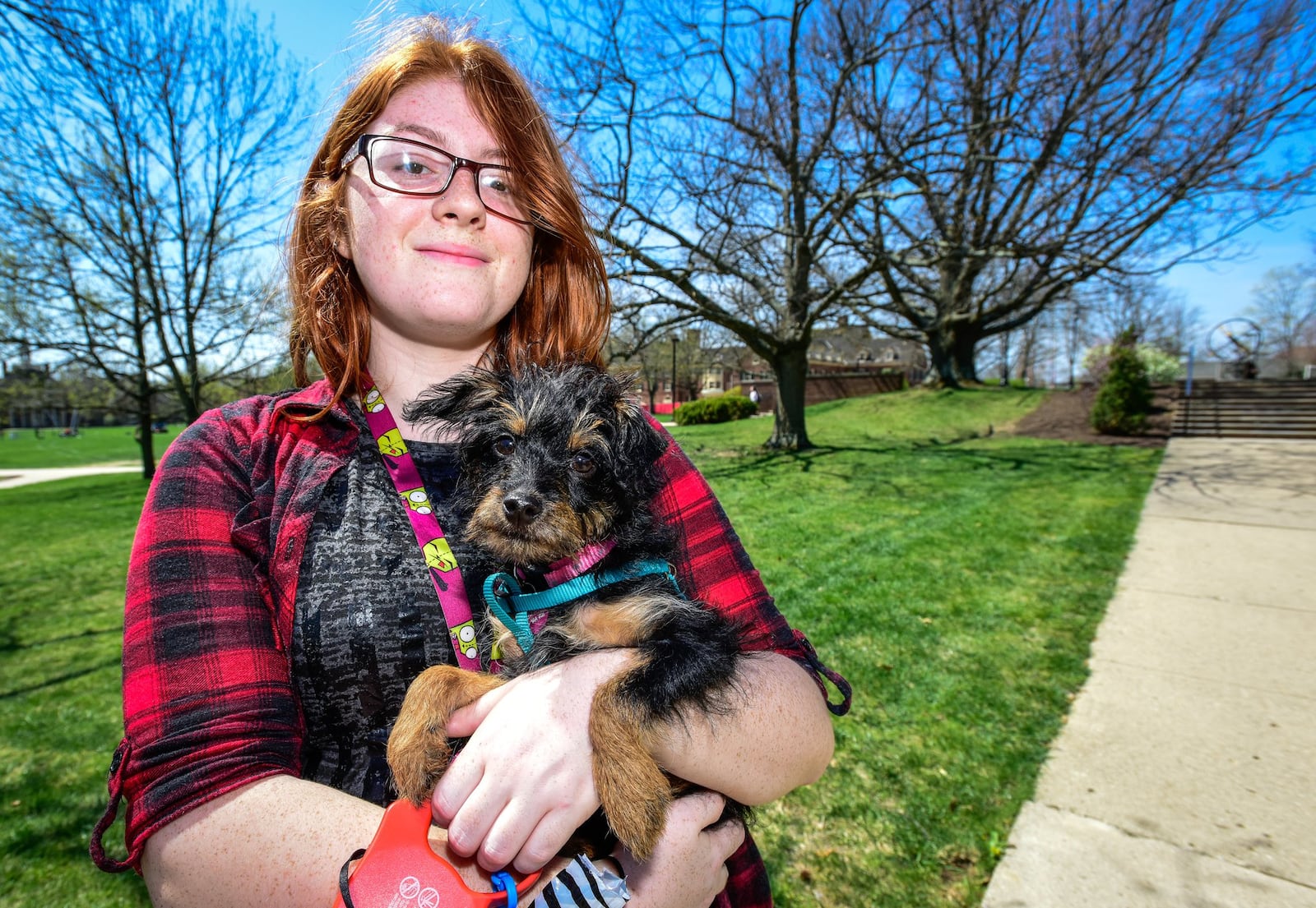 Miami University freshman Angela Ackerman stands with her Emotional Support dog, Raven, Wednesday, April 12 on the Miami University Campus in Oxford. 