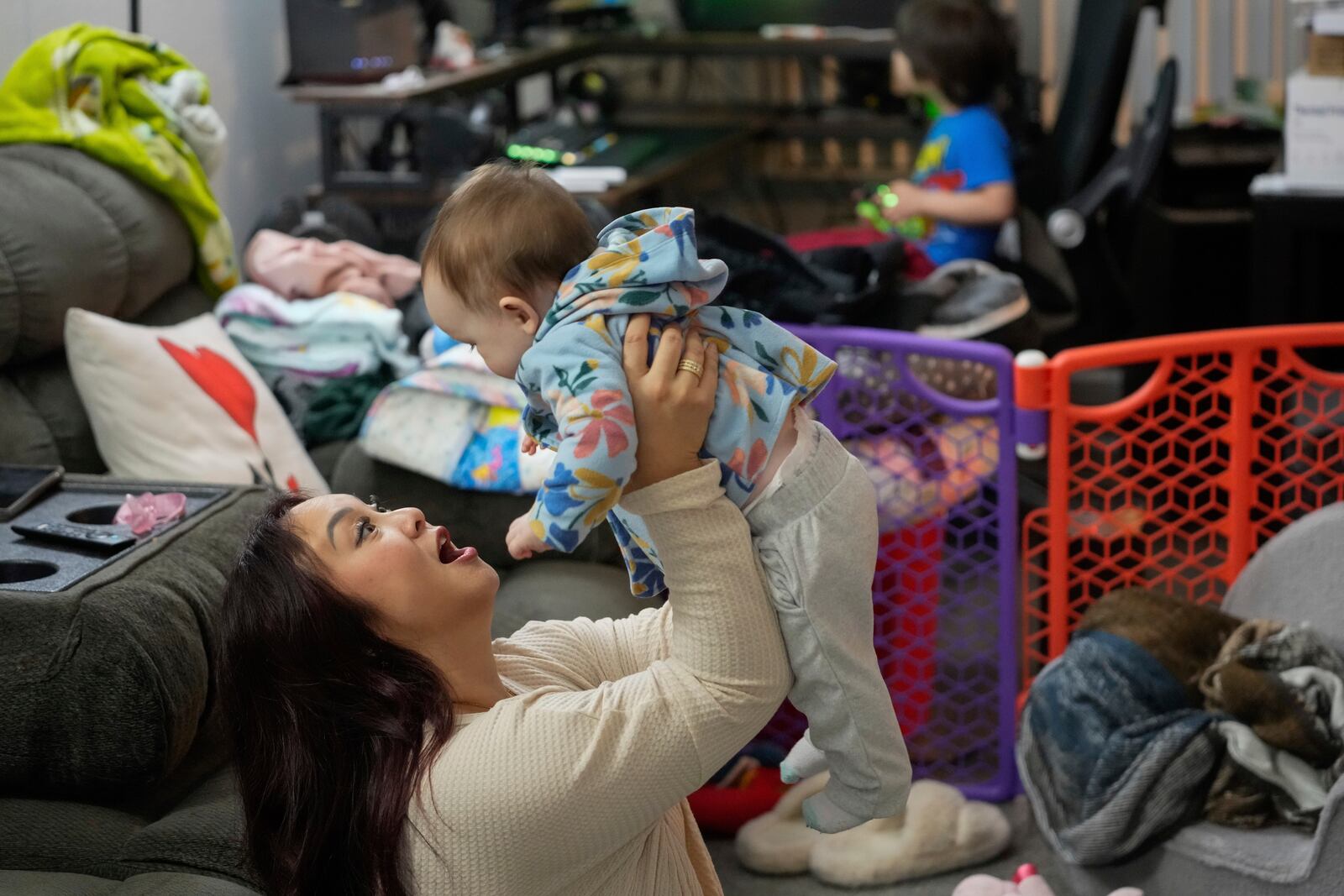 Jennifer Petersen, left, plays with her daughter Carolynn at their apartment in Campbell, Calif., Wednesday, Jan. 15, 2025. (AP Photo/Godofredo A. Vásquez)