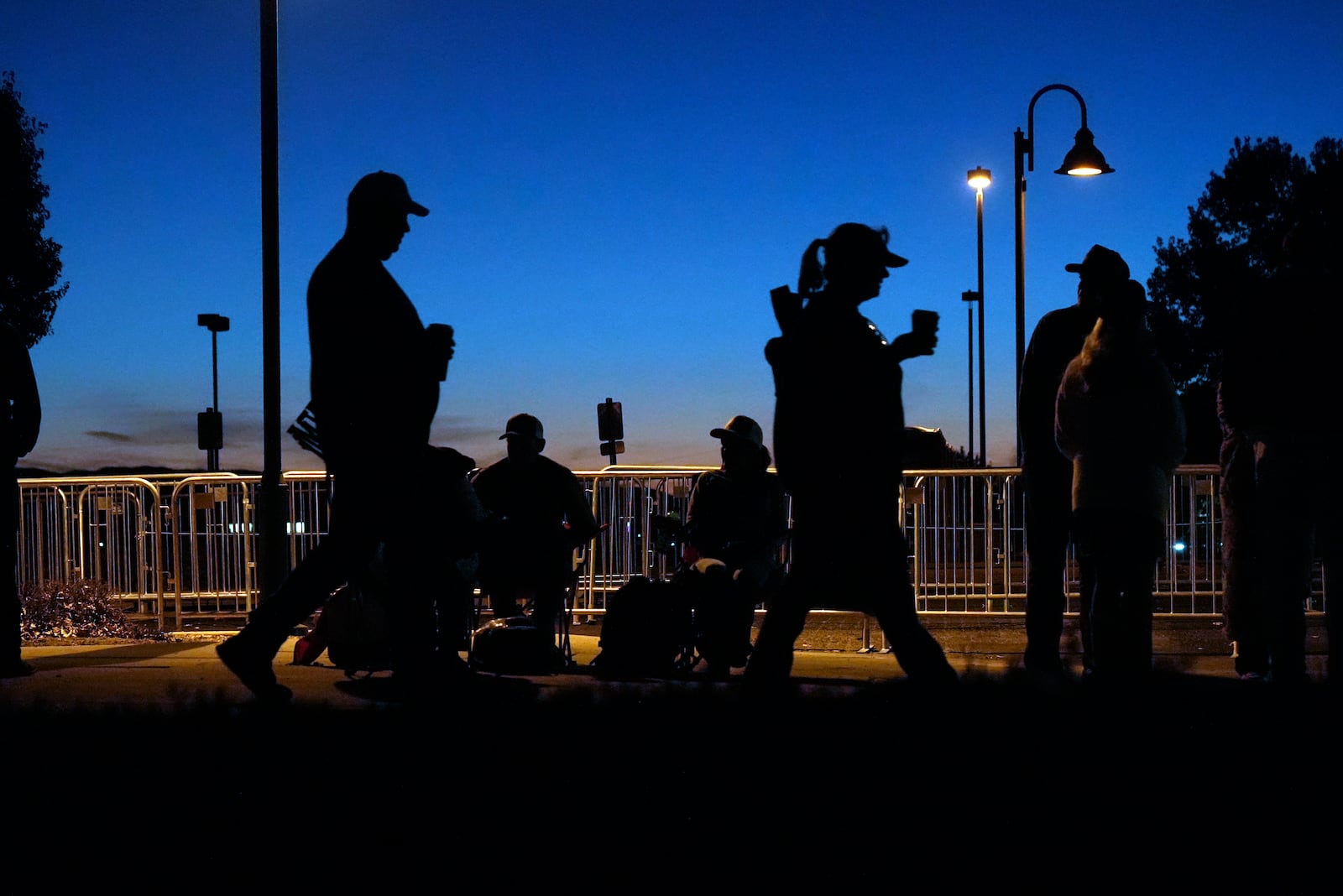 Supporters wait in line before Republican presidential nominee former President Donald Trump speaks at a campaign rally at the Findlay Toyota Arena Sunday, Oct. 13, 2024, in Prescott Valley, Ariz. (AP Photo/Ross D. Franklin)