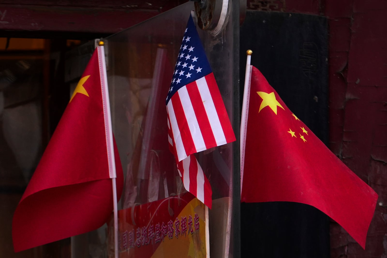 China and U.S. national flags are seen on display outside a souvenir shop in Beijing on Jan. 31, 2025. (AP Photo/Andy Wong)