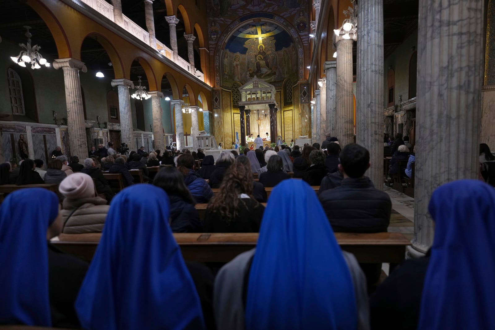 Pope's Vicar for Rome, Cardinal Baldassare Reina celebrates mass for the health of Pope Francis at the Church of the Argentinas, Santa Maria Addolorata in Rome, Italy Tuesday, Feb. 25, 2025. (AP Photo/Kirsty Wigglesworth)