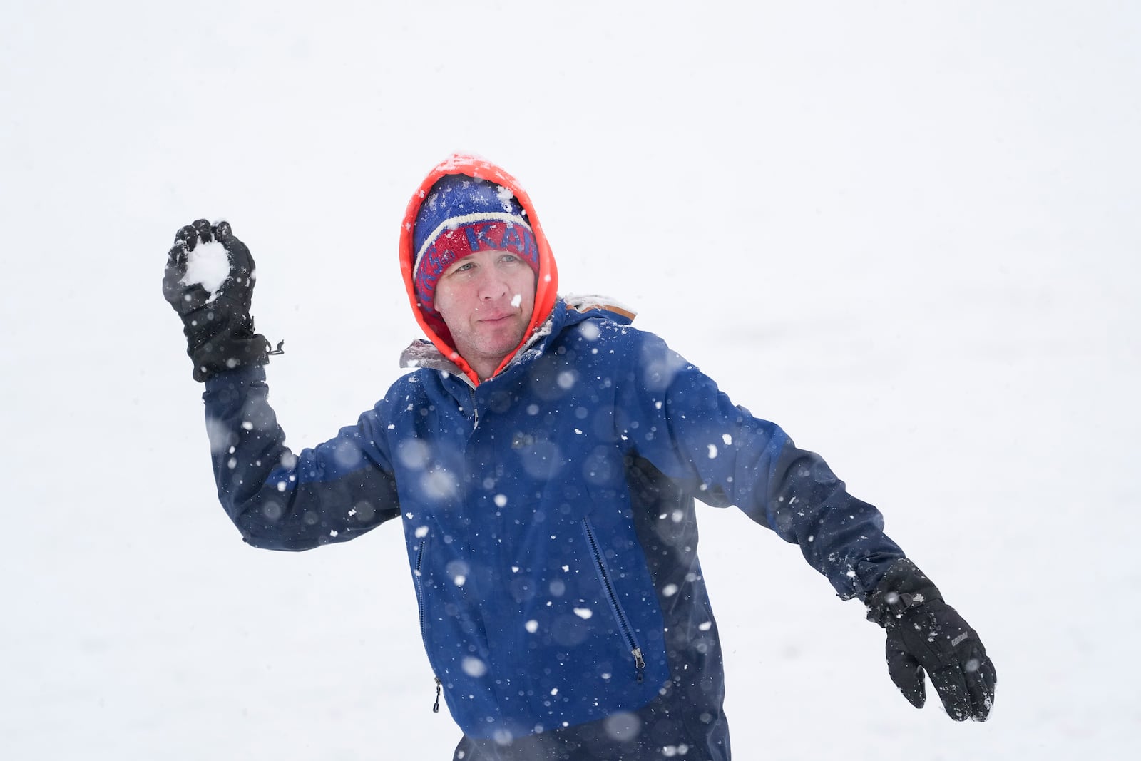 Dan Chappell throws a snowball as he plays under the snow, Friday, Jan. 10, 2025, in Nashville, Tenn. (AP Photo/George Walker IV)