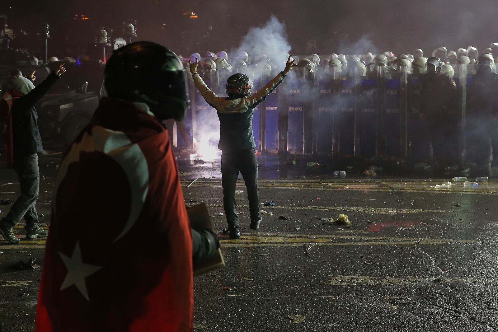 Protesters face off riot policemen during a protest after Istanbul's Mayor Ekrem Imamoglu was arrested and sent to prison, in Istanbul, Turkey, Sunday, March 23, 2025. (AP Photo/Huseyin Aldemir)