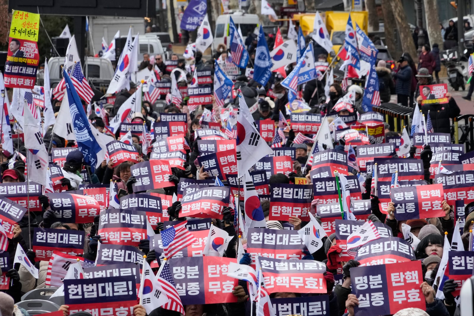 Supporters of impeached South Korean President Yoon Suk Yeol stage a rally to oppose his impeachment near the Constitutional Court in Seoul, South Korea, Tuesday, Feb. 25, 2025. The letters read "Impeachment invalid." (AP Photo/Ahn Young-joon)