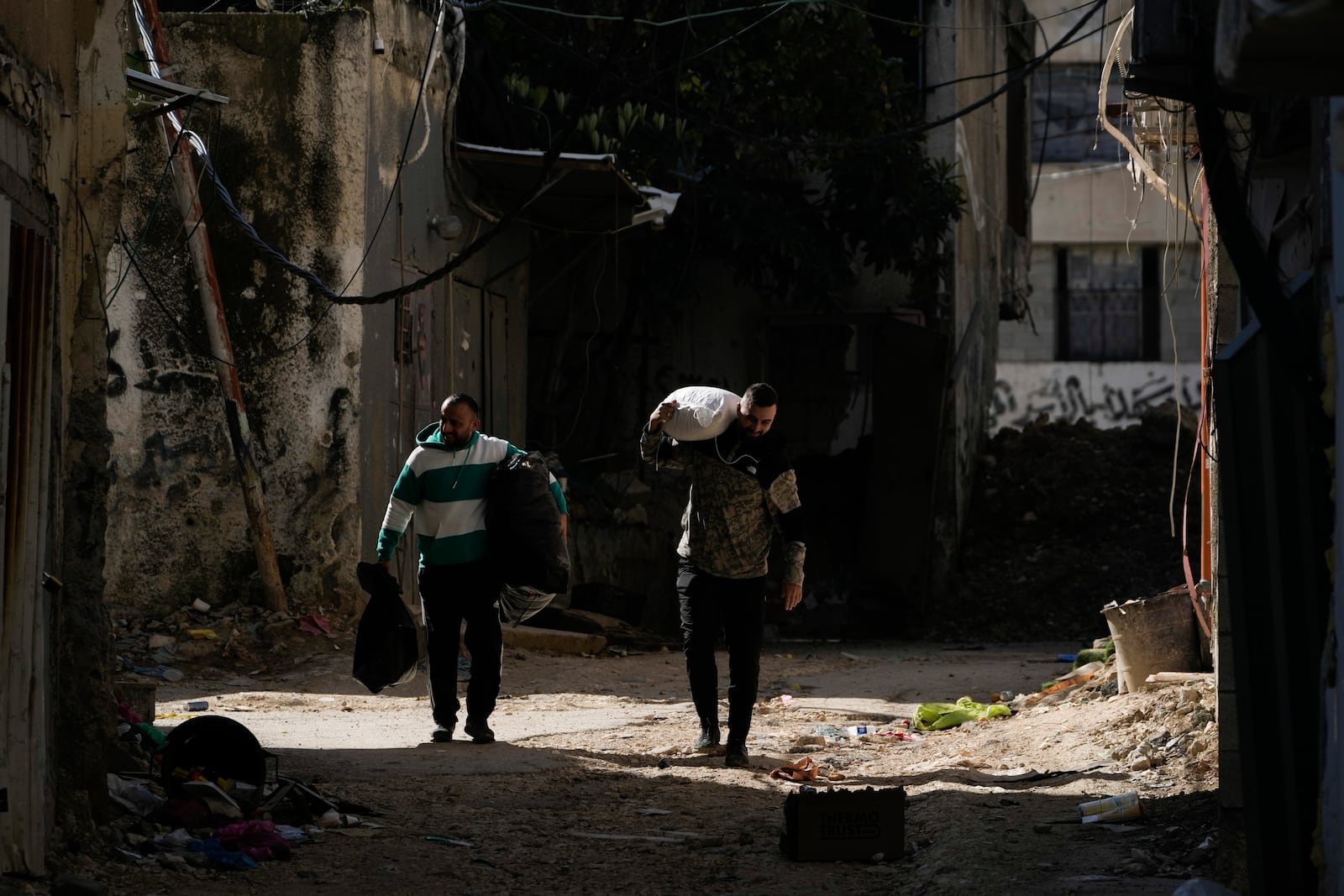 Residents of the West Bank urban refugee camp of Nur Shams evacuate their homes and carry their belongings as the Israeli military continues its operation in the area on Wednesday, Feb. 26, 2025. (AP Photo/Majdi Mohammed)