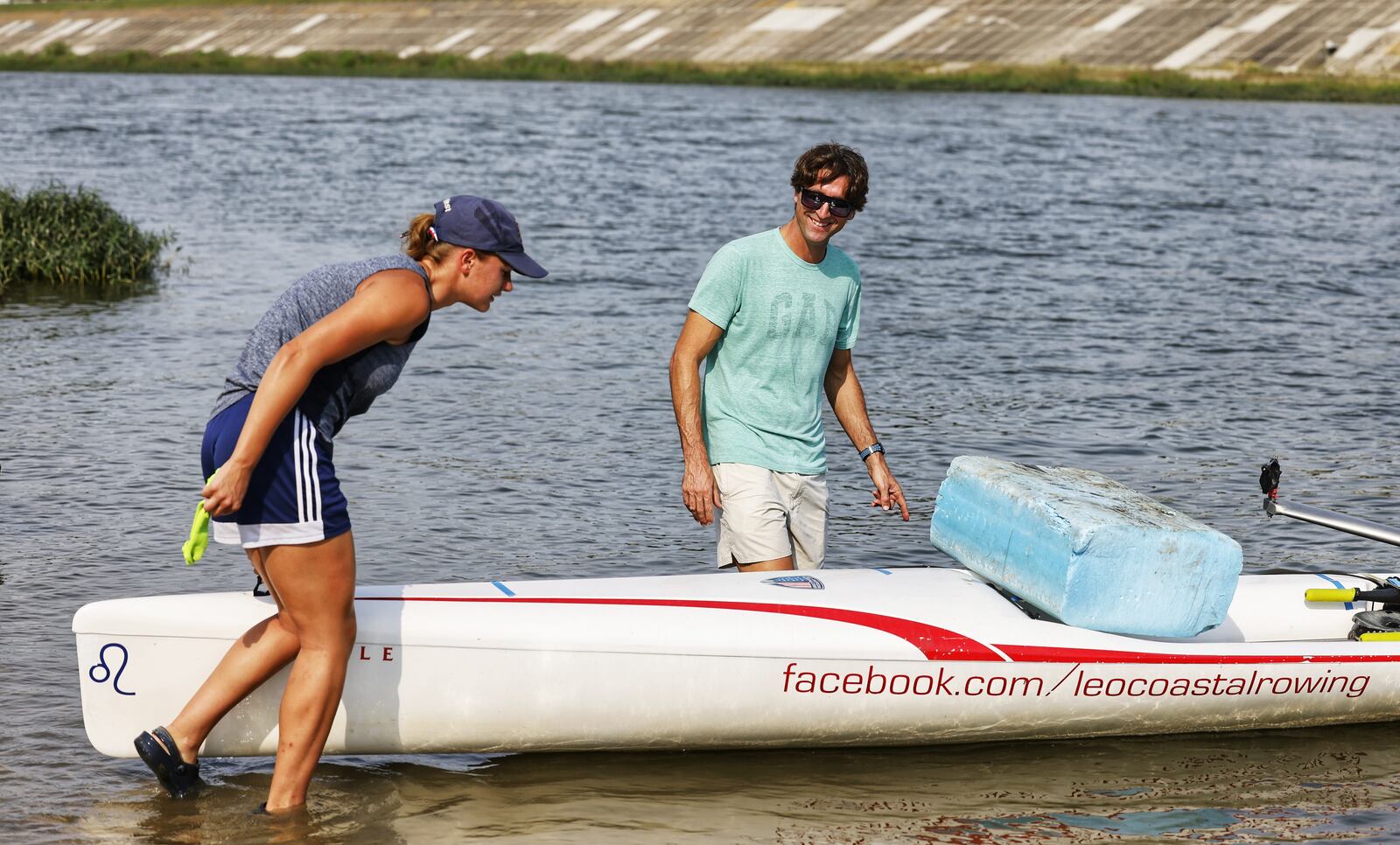 Marc Oria, head coach of Great Miami Crew, communicates with rower Cassidy Norton during practice Wednesday, Aug. 11, 2021 on the Great Miami River in Hamilton. Oria, Norton and a few others will be travelling to Barcelona, Spain to train for a world competition in Portugal. Norton will compete as a single in the coastal rowing boat competition. NICK GRAHAM / STAFF