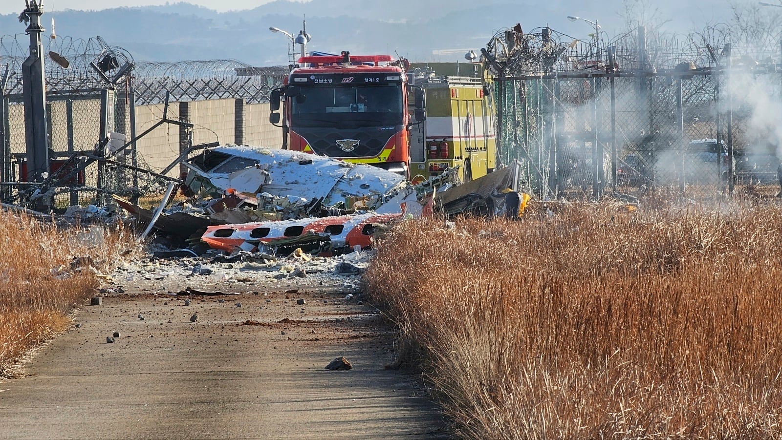 Fire engines work to extinguish a fire at the Muan International Airport in Muan, South Korea, Sunday, Dec. 29, 2024. (Maeng Dae-hwan/Newsis via AP)