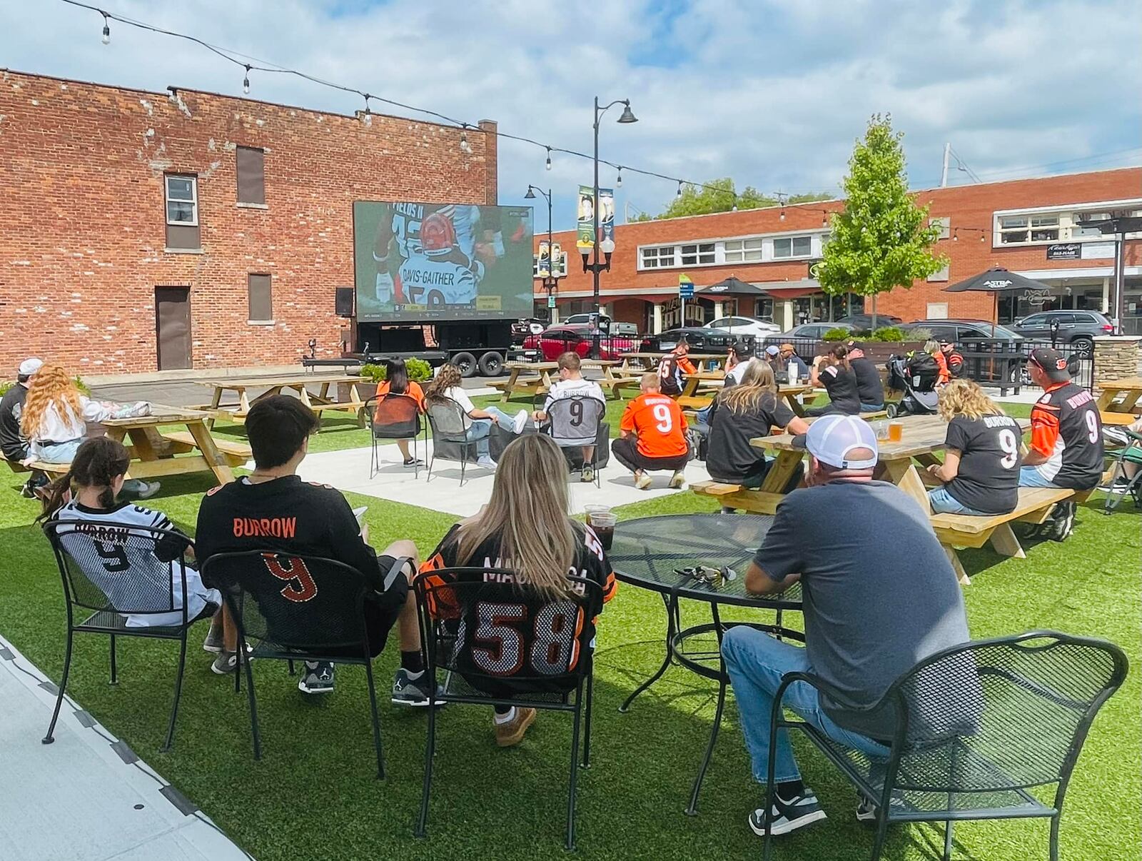 People gathered Sept. 10, 2023 at Hamilton's Urban Backyard on Main Street in Hamilton to watch the Cincinnati Bengals play the Cleveland Browns. The screen showing the game was provided by Chatterbox Sports. CONTRIBUTED