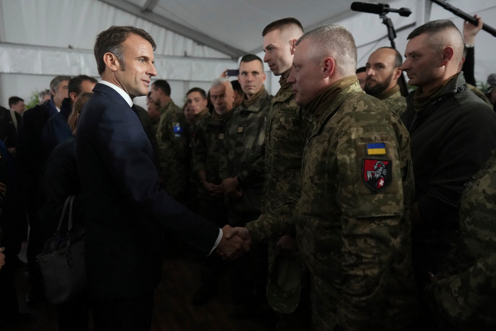 FILE - French President Emmanuel Macron speaks with Ukrainian soldiers in a military camp in eastern France, Wednesday, Oct. 9, 2024. (AP Photo/Thibault Camus, Pool File)