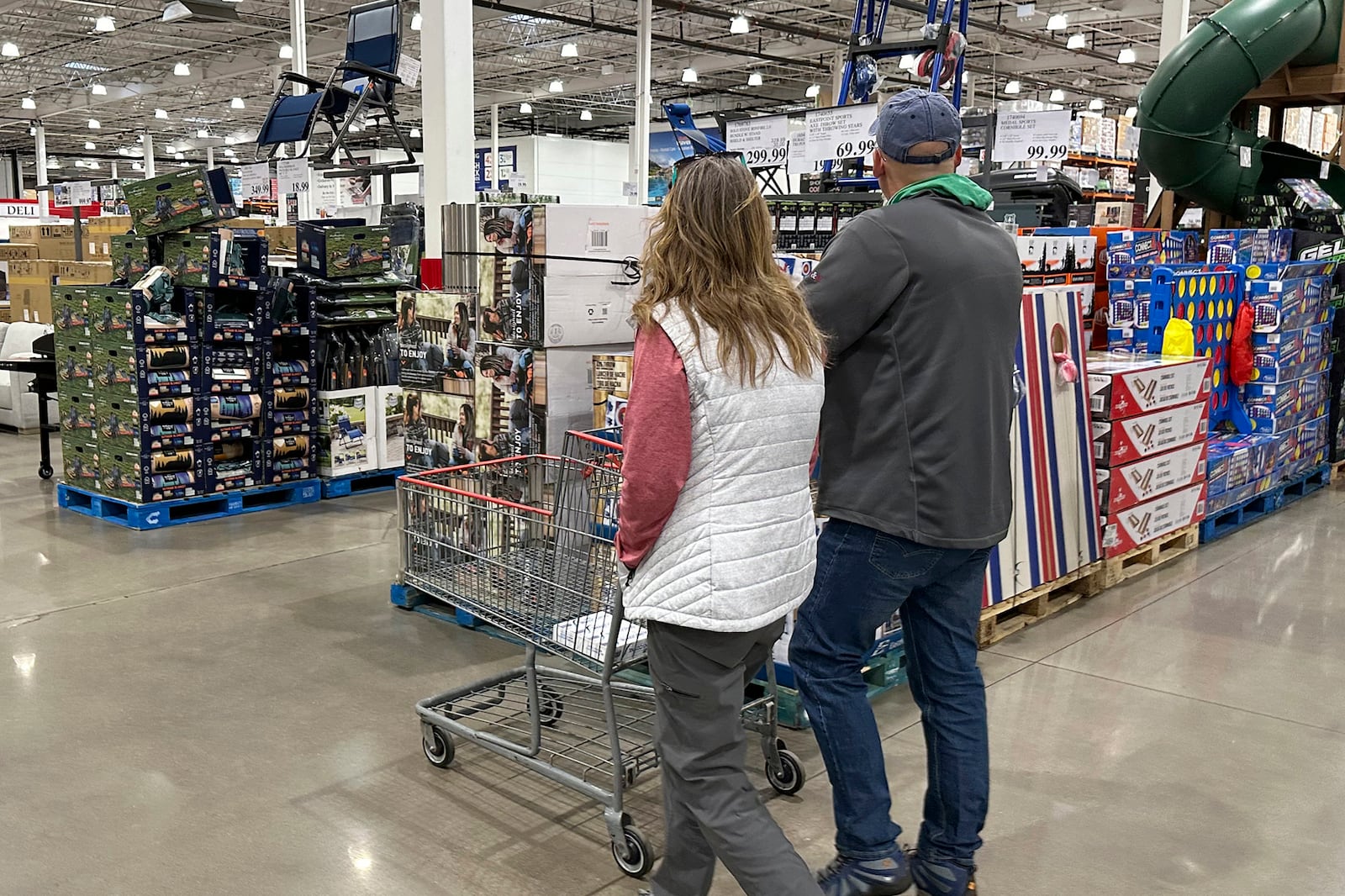 FILE - Shoppers pass displays of goods in a Costco warehouse Sunday, Feb. 25, 2024, in Sheridan, Colo. (AP Photo/David Zalubowski, File)