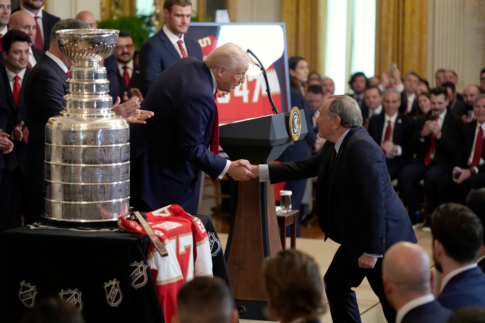 President Donald Trump, left, greets NHL Commissioner Gary Bettman during an event to honor the 2024 NHL Stanley Cup champion Florida Panthers hockey team in the East Room of the White House, Monday, Feb. 3, 2025, in Washington. (AP Photo/Evan Vucci)