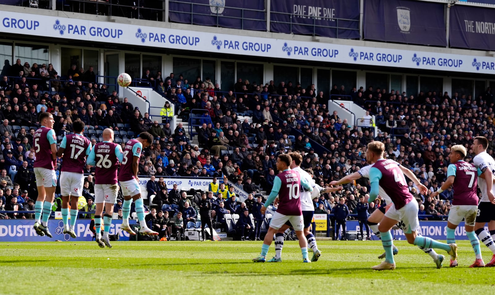 Preston North End's Robbie Brady, partially hidden in background, center, scores their side's first goal of the game during the English FA Cup fifth round soccer match between Preston North End and Burnley, at Deepdale, in Preston, England, Saturday, March 1, 2025. (Nick Potts/PA via AP)