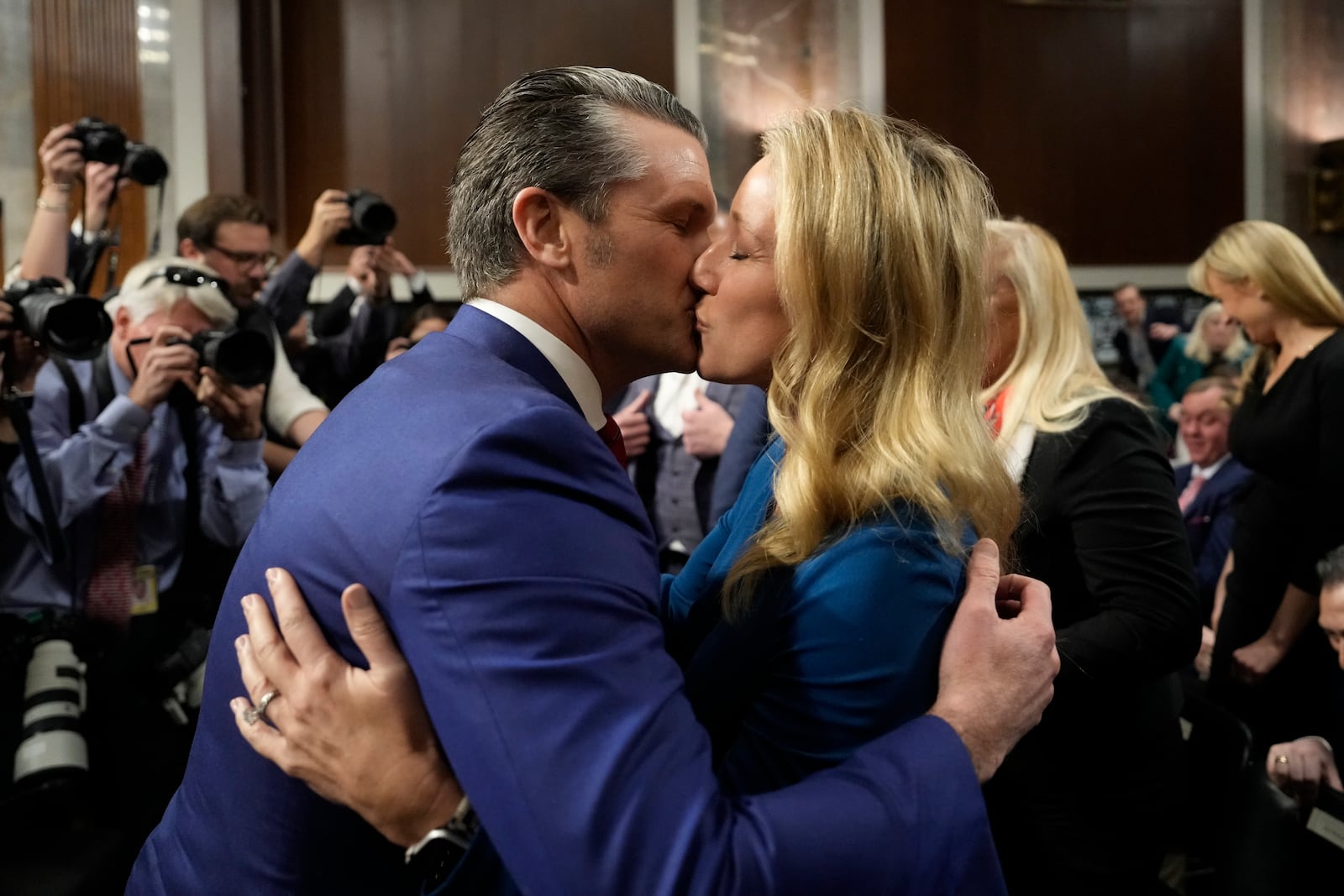 Pete Hegseth, President-elect Donald Trump's choice to be Defense secretary, embraces his wife Jennifer Rauche at the completion of a Senate Armed Services Committee hearing for his confirmation, at the Capitol in Washington, Tuesday, Jan. 14, 2025. (AP Photo/Ben Curtis)