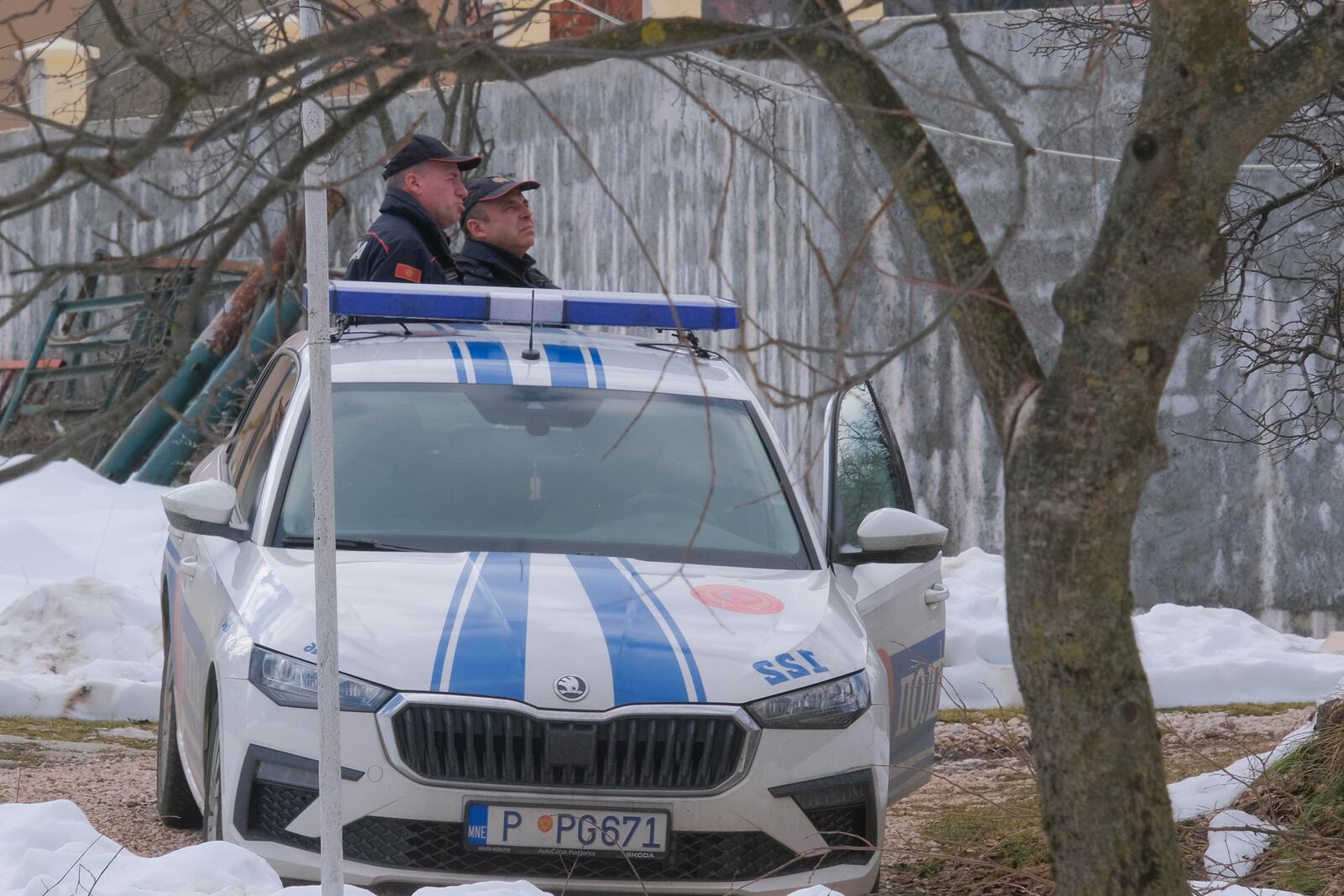 Police officers stand guard at the home of a gunman after a shooting incident, in Cetinje, 36 kilometers (22 miles) west of Podogrica, Montenegro, Thursday, Jan. 2, 2025. (AP Photo/Risto Bozovic)