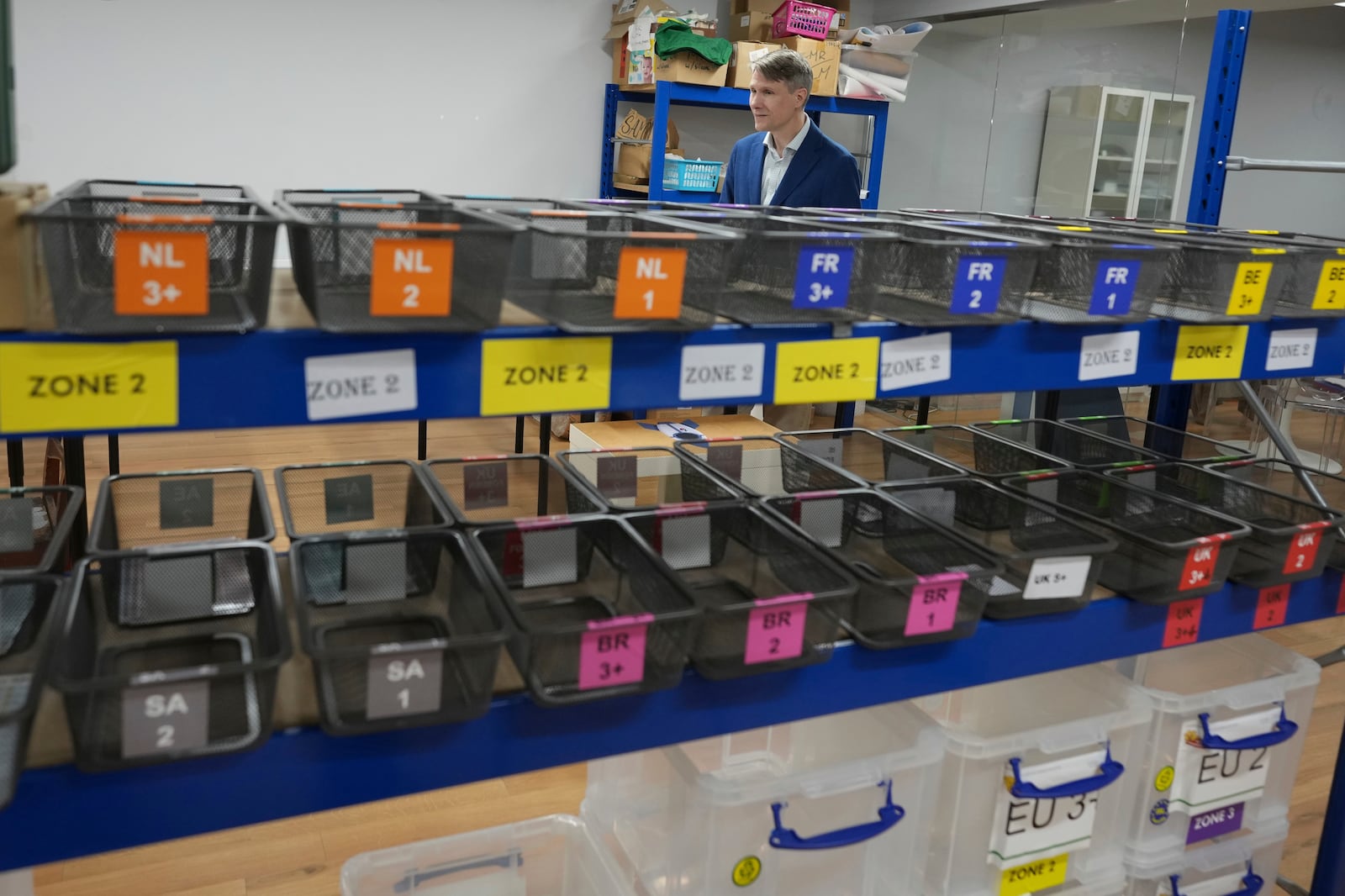 Labels for school children come of the cutting machine at 'My Nametags' factory in London, Thursday, Jan. 30, 2025. (AP Photo/Alastair Grant)